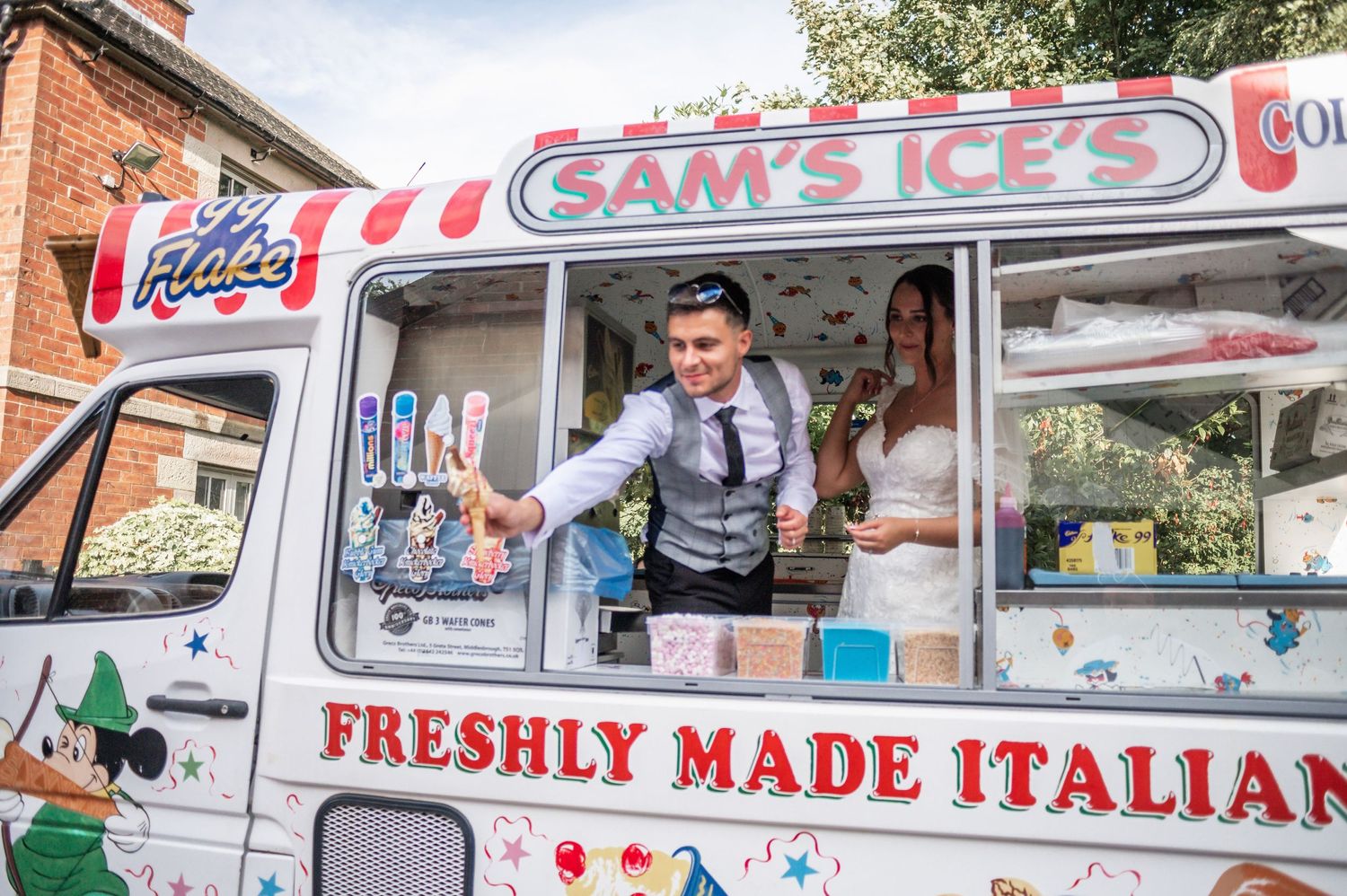 Vintage ice cream truck serving treats at a wedding with Italian-style decor.