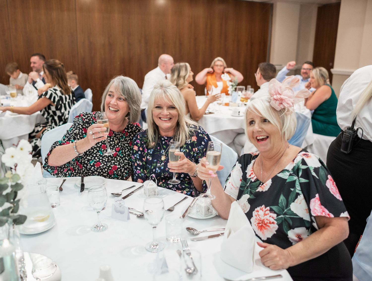 Wedding reception dinner with decorated tables and festive atmosphere.