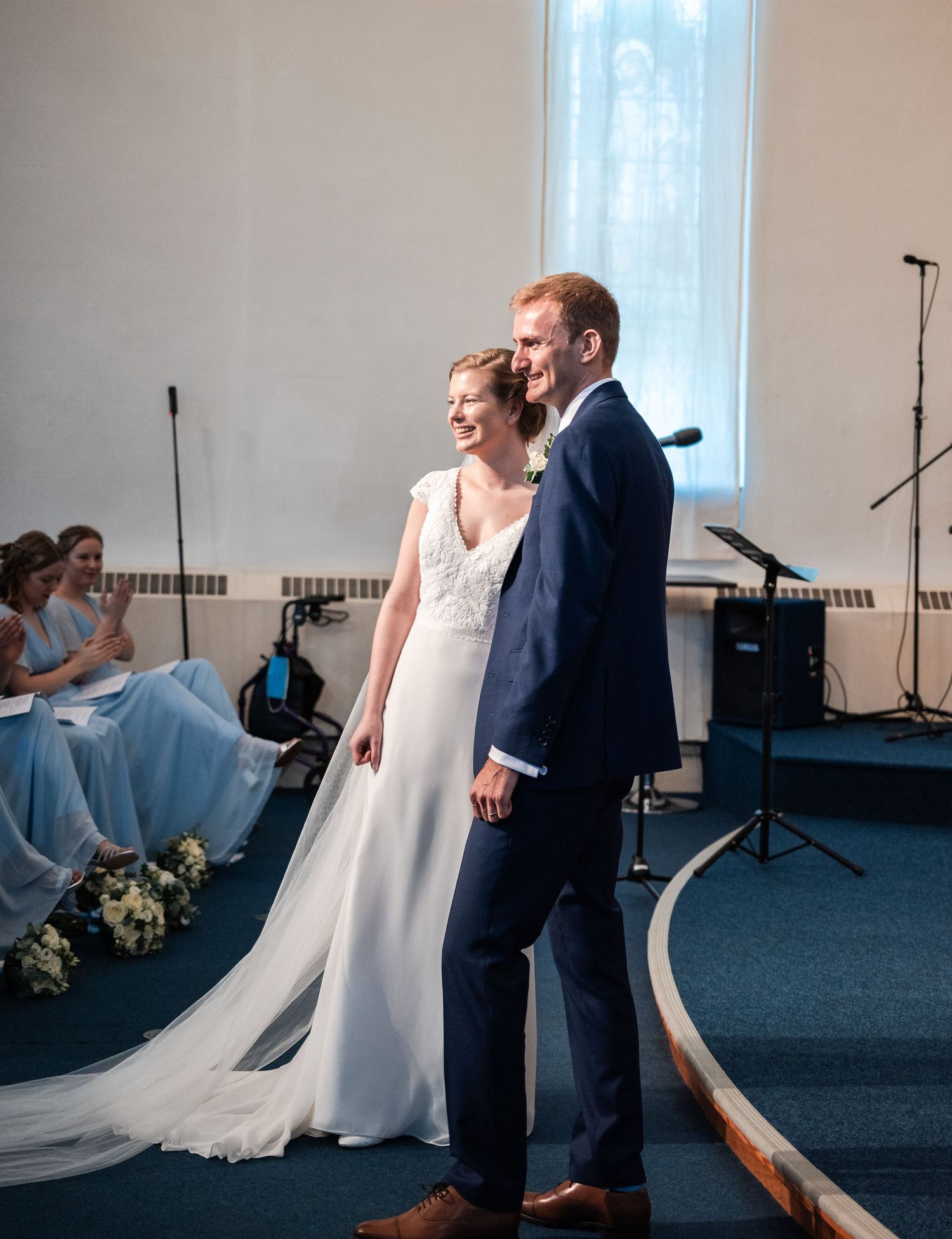 Wedding couple sharing a lighthearted moment during their ceremony in a church setting.