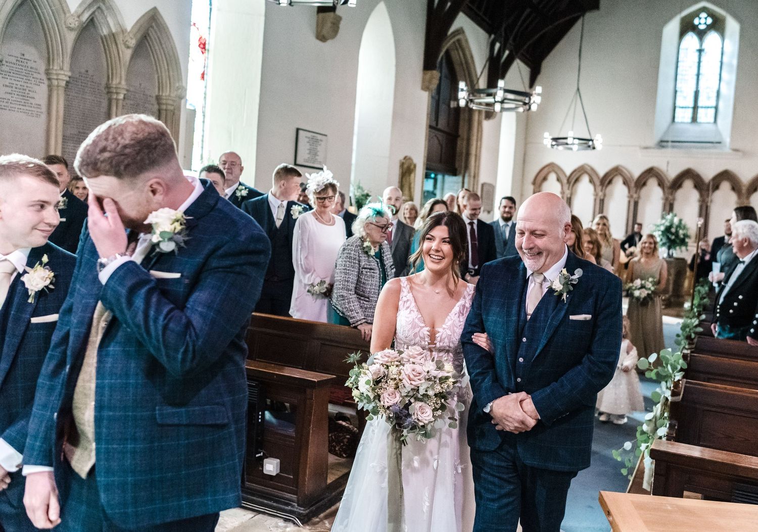 Emotional wedding ceremony moment captured in a historic church setting.