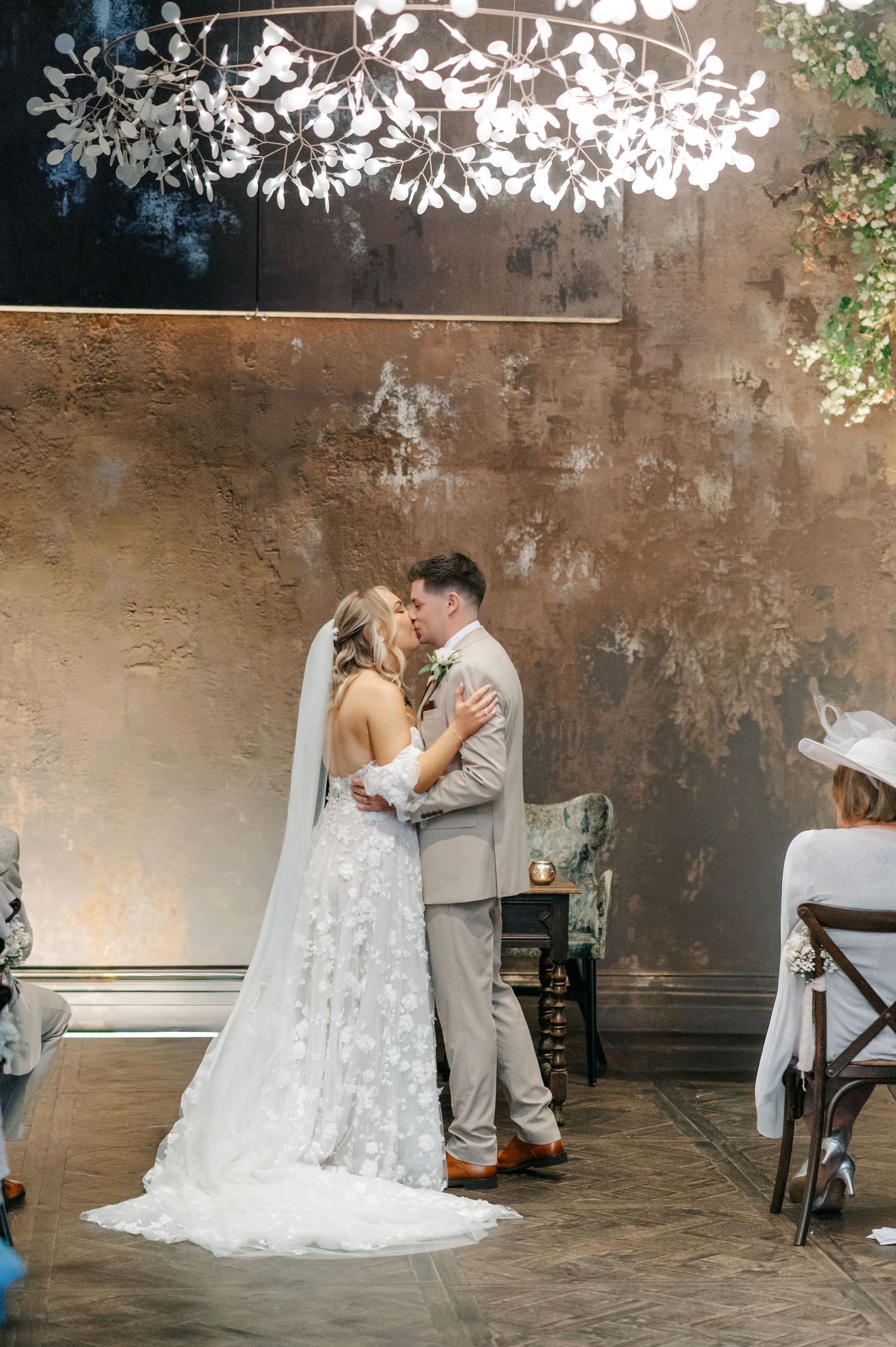Wedding ceremony space with romantic lighting and exposed brick walls.