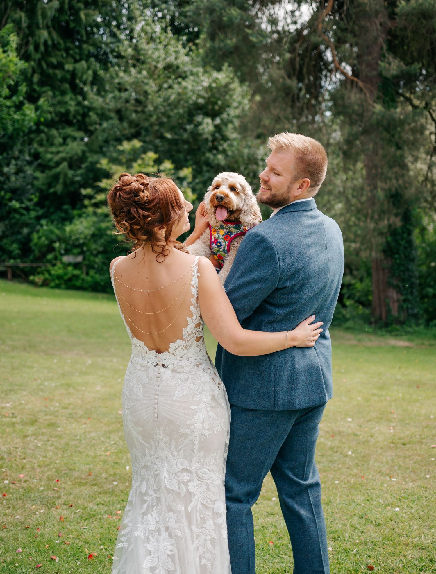 Couple dancing outdoors in a garden setting during their wedding celebration.