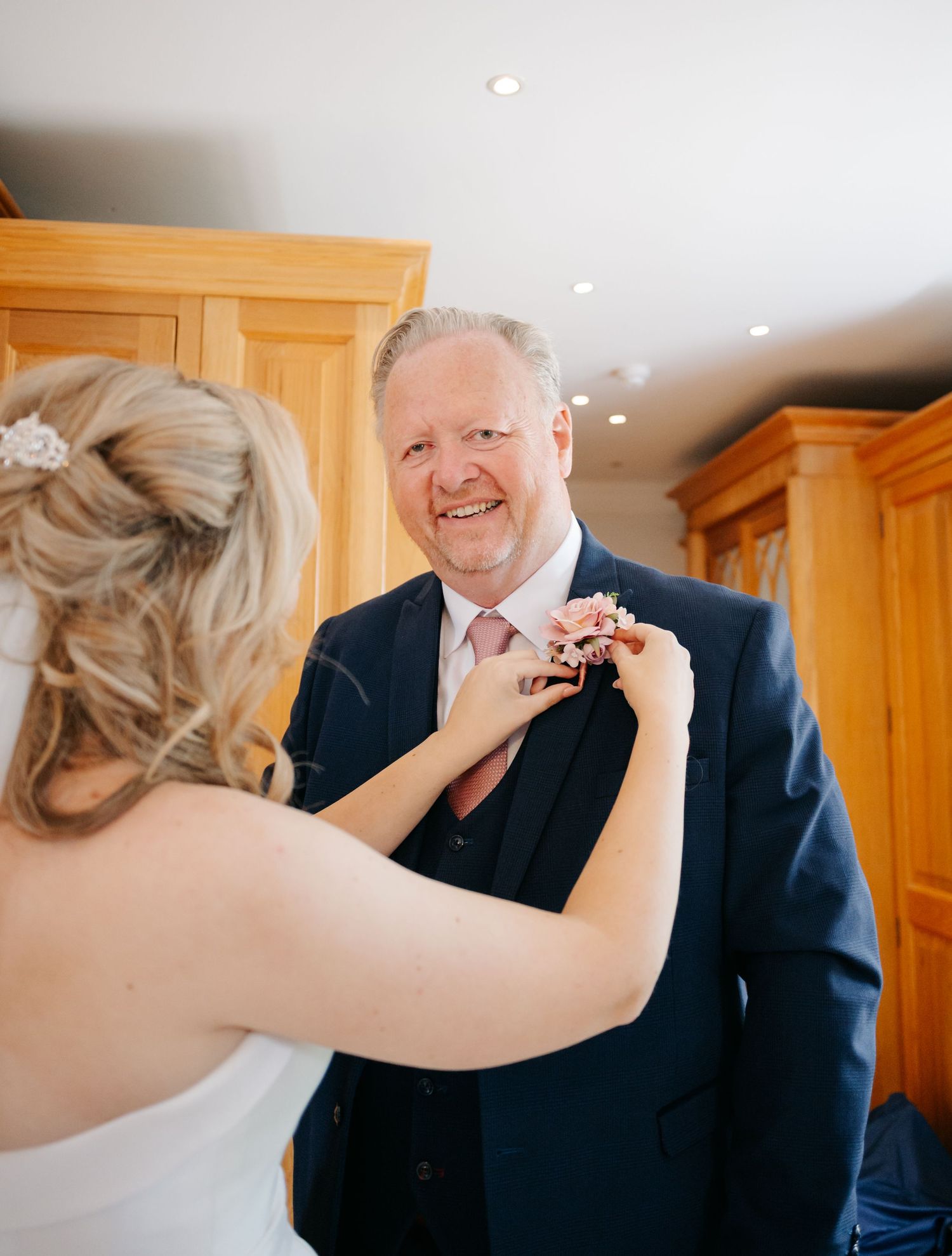 Sequential shots of a heartfelt father-daughter moment during wedding preparations.