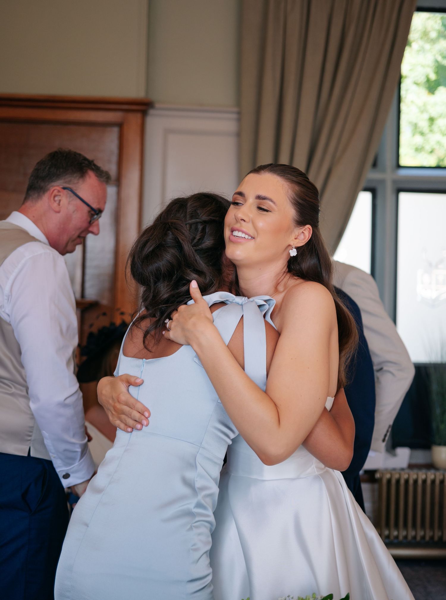 Wedding guests dancing and celebrating in formal attire.