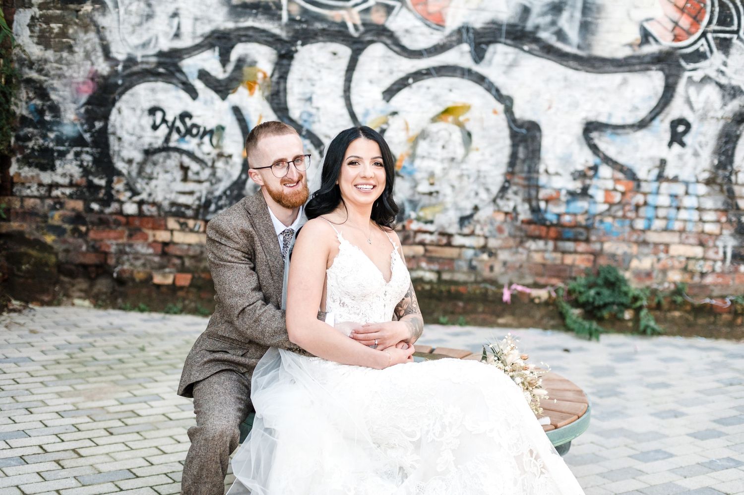 wedding couple near graffiti wall on urban cobblestone street, 99 Mary Street, Sheffield, Yorkshire urban winter wedding