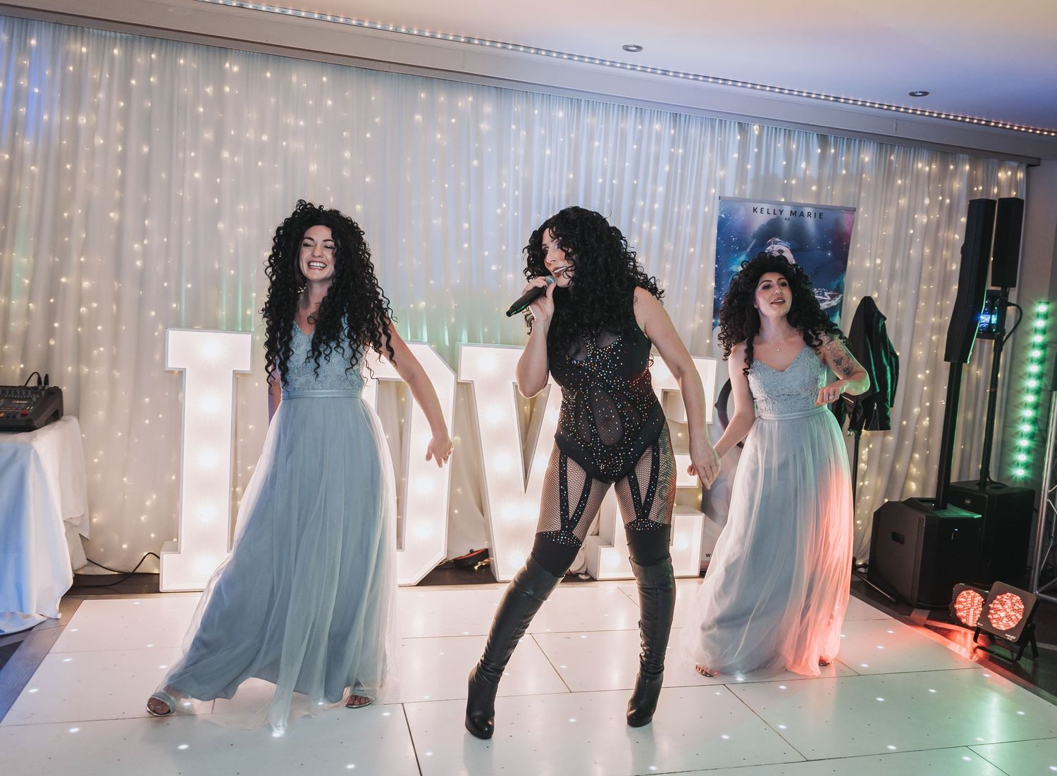 Festive wedding reception dance floor scene with dramatic lighting effects.