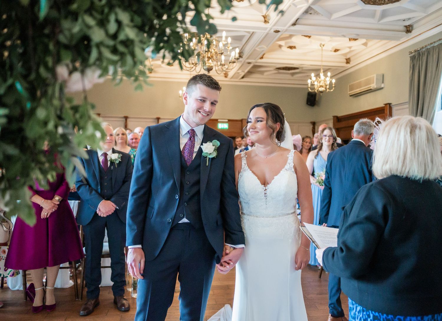 Newlyweds celebrating during wedding reception in elegant ballroom setting.