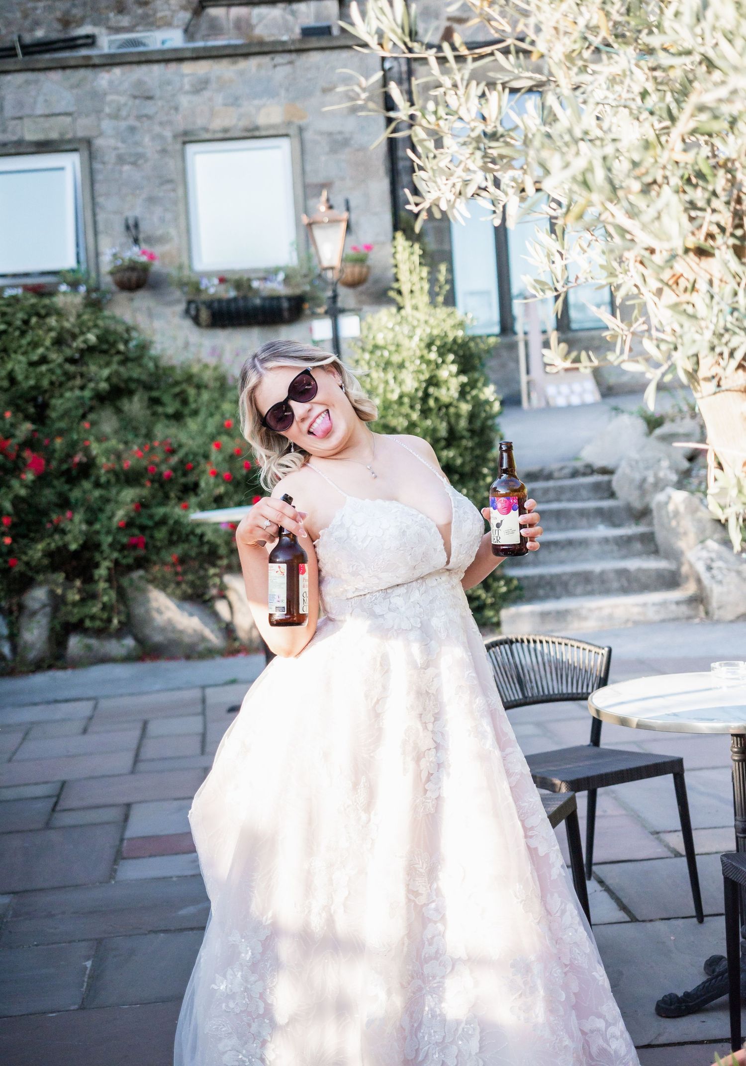 A celebratory moment on a stone patio with sunglasses and a beverage.