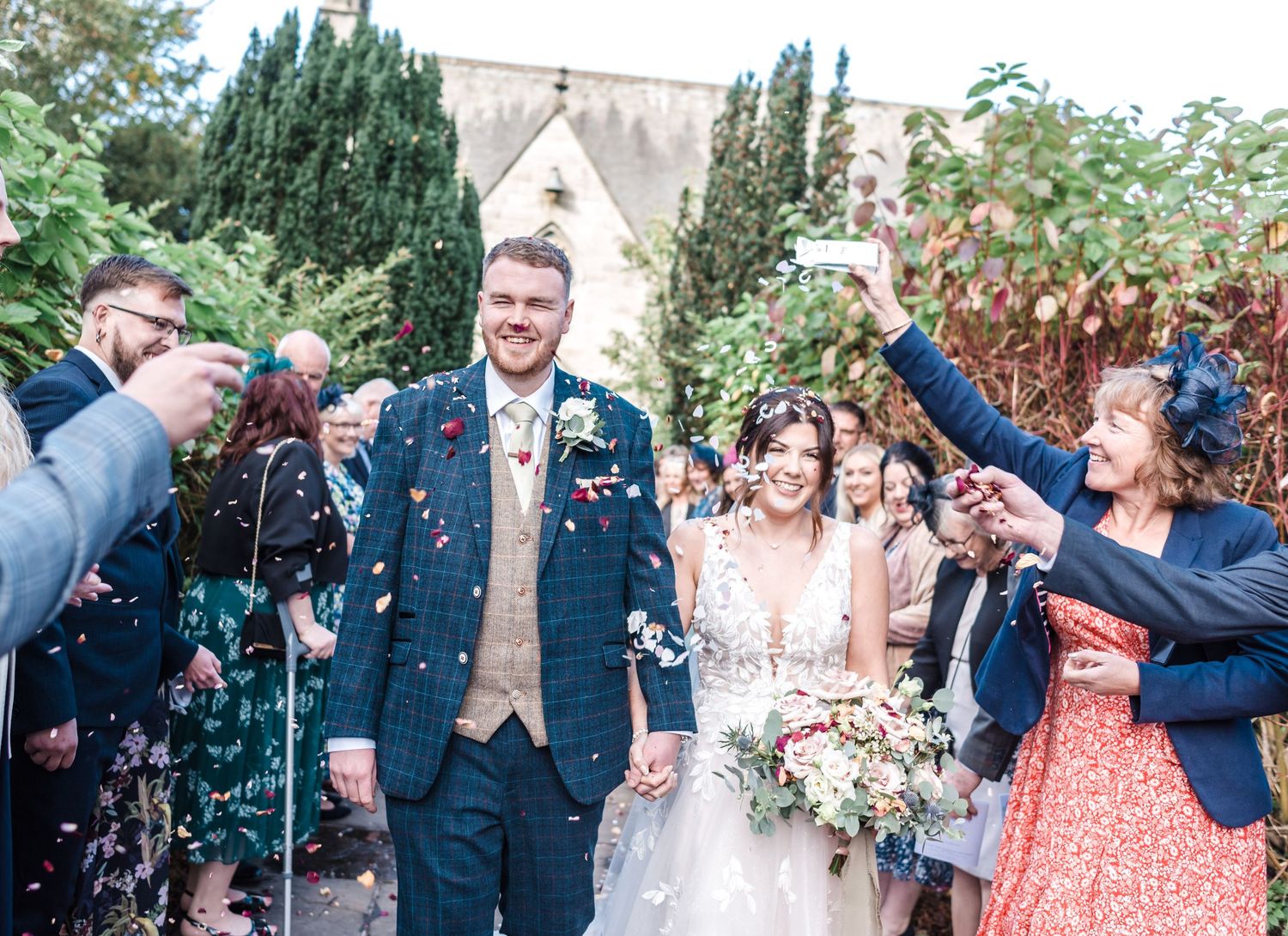 Wedding guests shower the happy couple with confetti outside a church haarlem mill derbyshire wedding photography