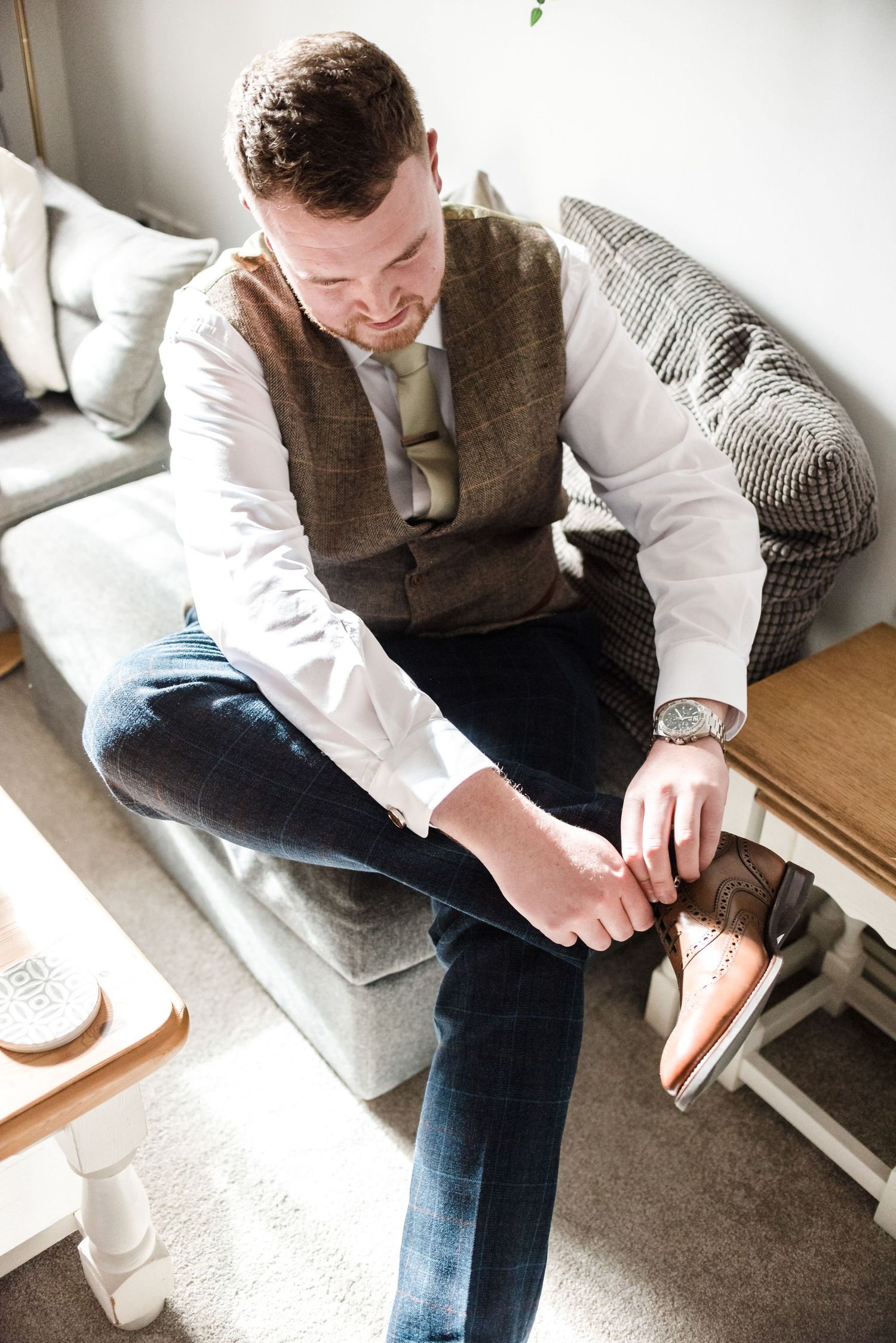Behind the scenes of wedding preparation with stylists helping with final touches.