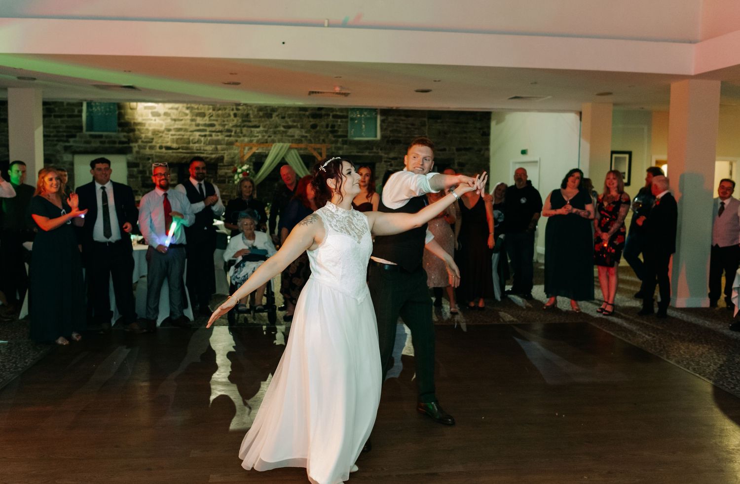 Wedding reception dance floor panorama showing guests celebrating.
