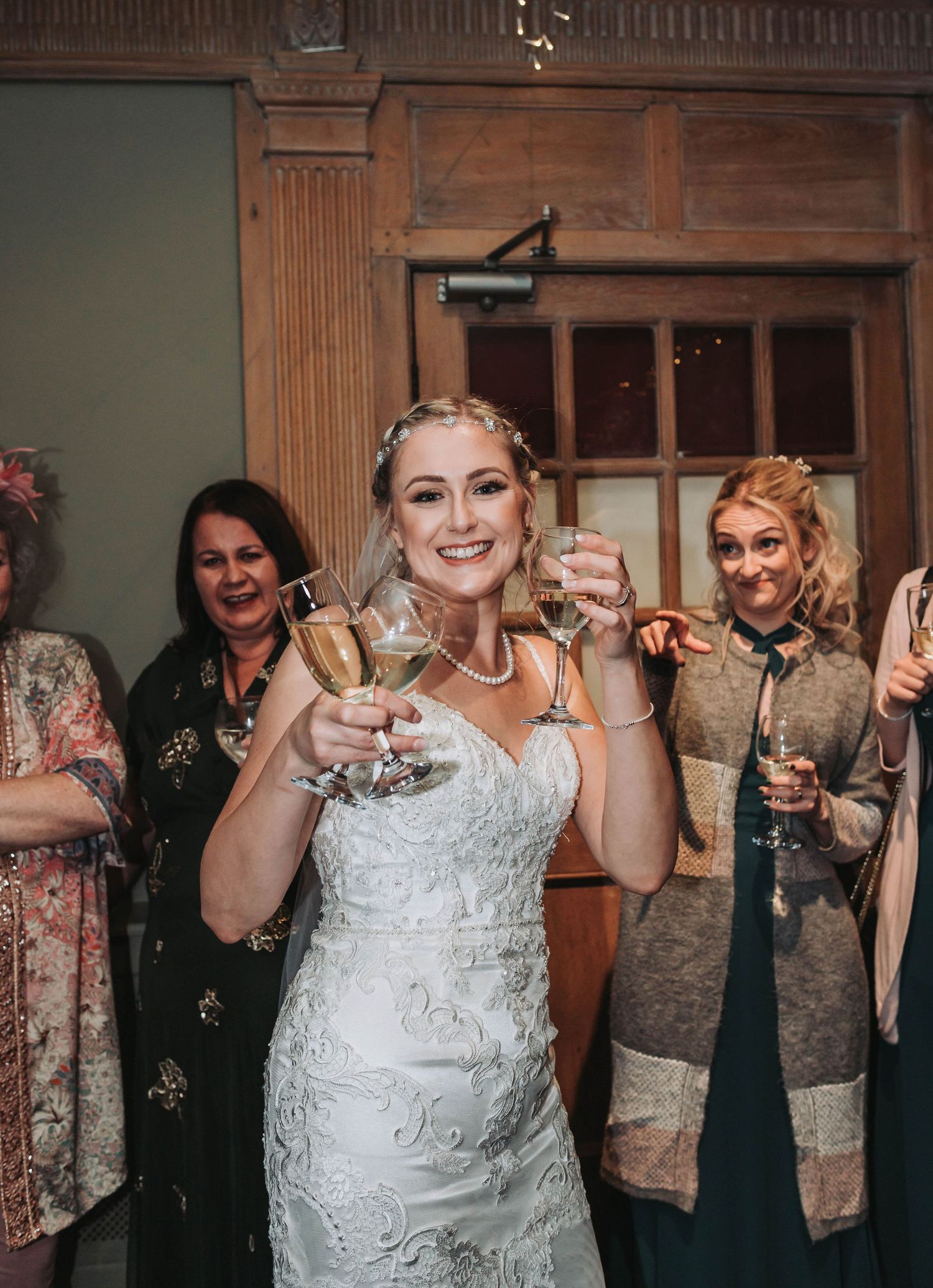 Celebratory toast moment at wedding reception with guests.