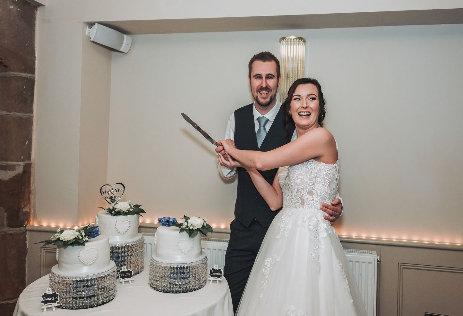 Romantic first dance with twinkling fairy light backdrop at wedding reception.
