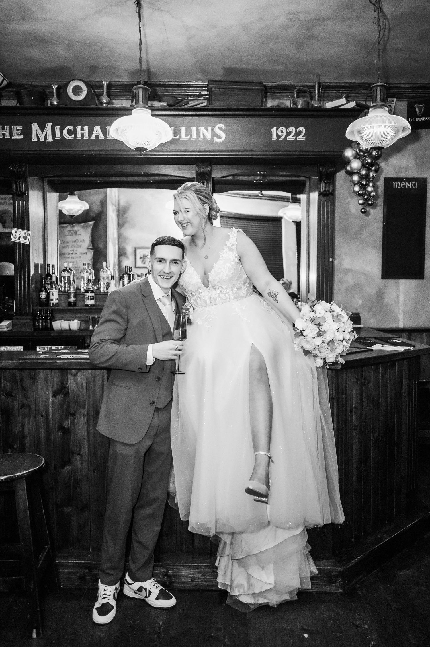 Black and white photos of couple sharing laughs in vintage pub setting.