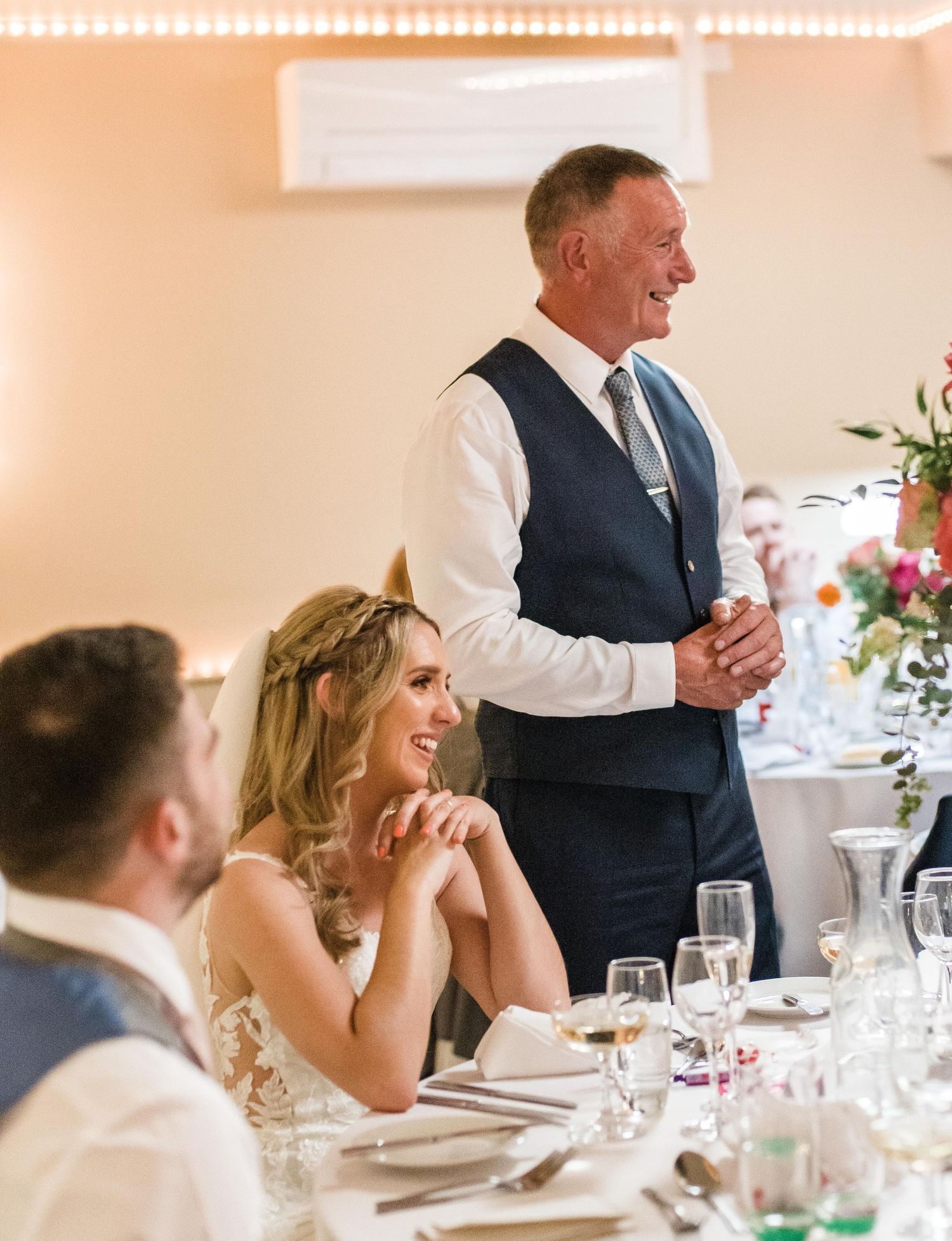 Reception dinner scene with elegant table settings and warm ambient lighting.