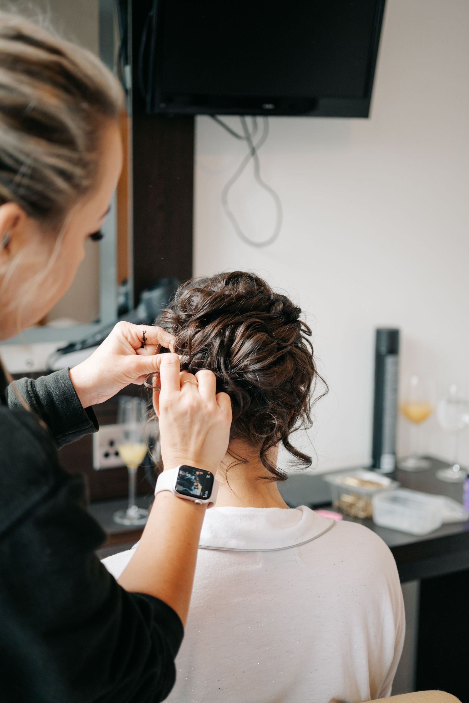 Close-up shots of a haircut in progress showing someone getting their hair trimmed with clippers in a salon.