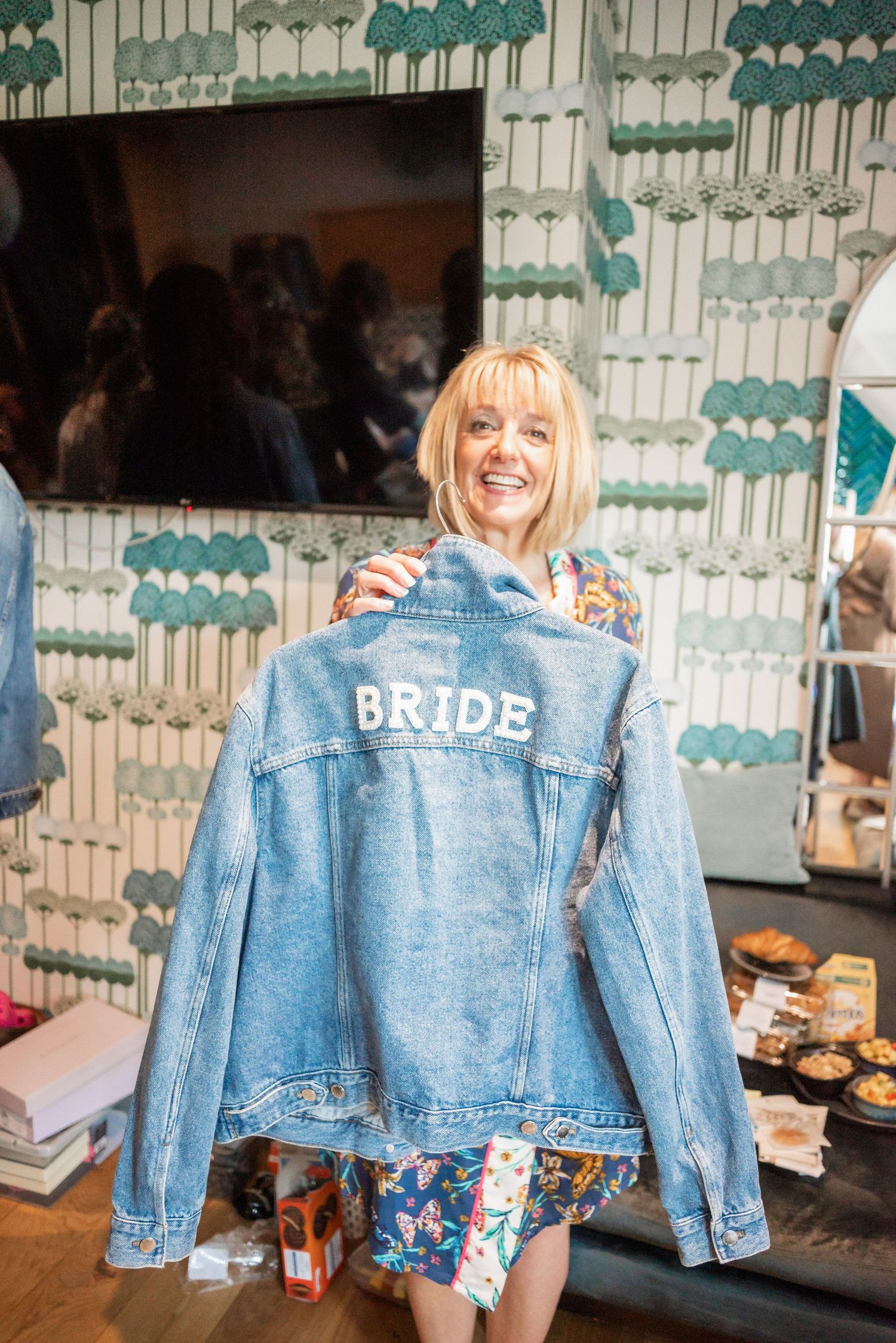 Custom denim bride jacket displayed at wedding celebration.