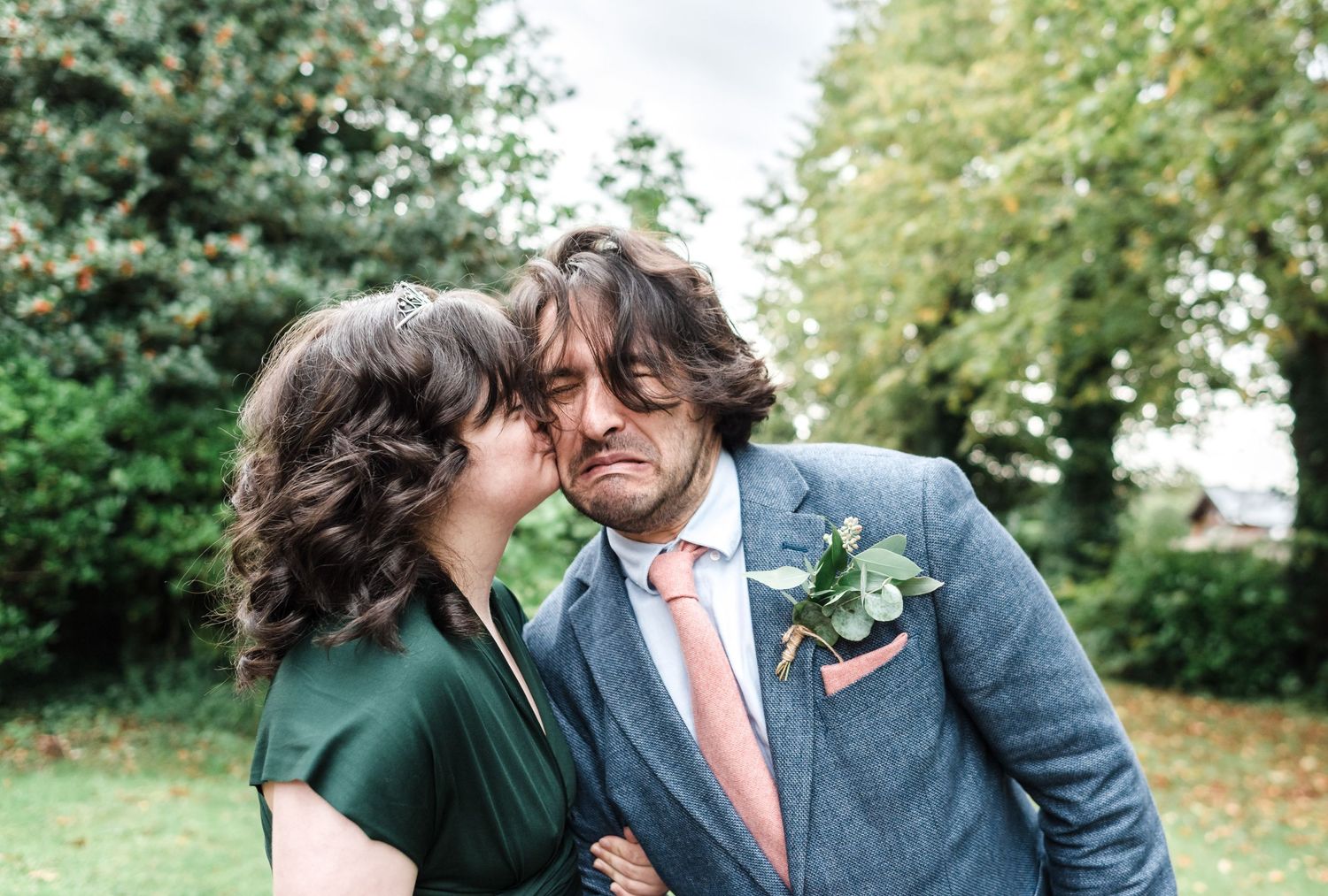 Romantic couple shares intimate moment in garden setting.