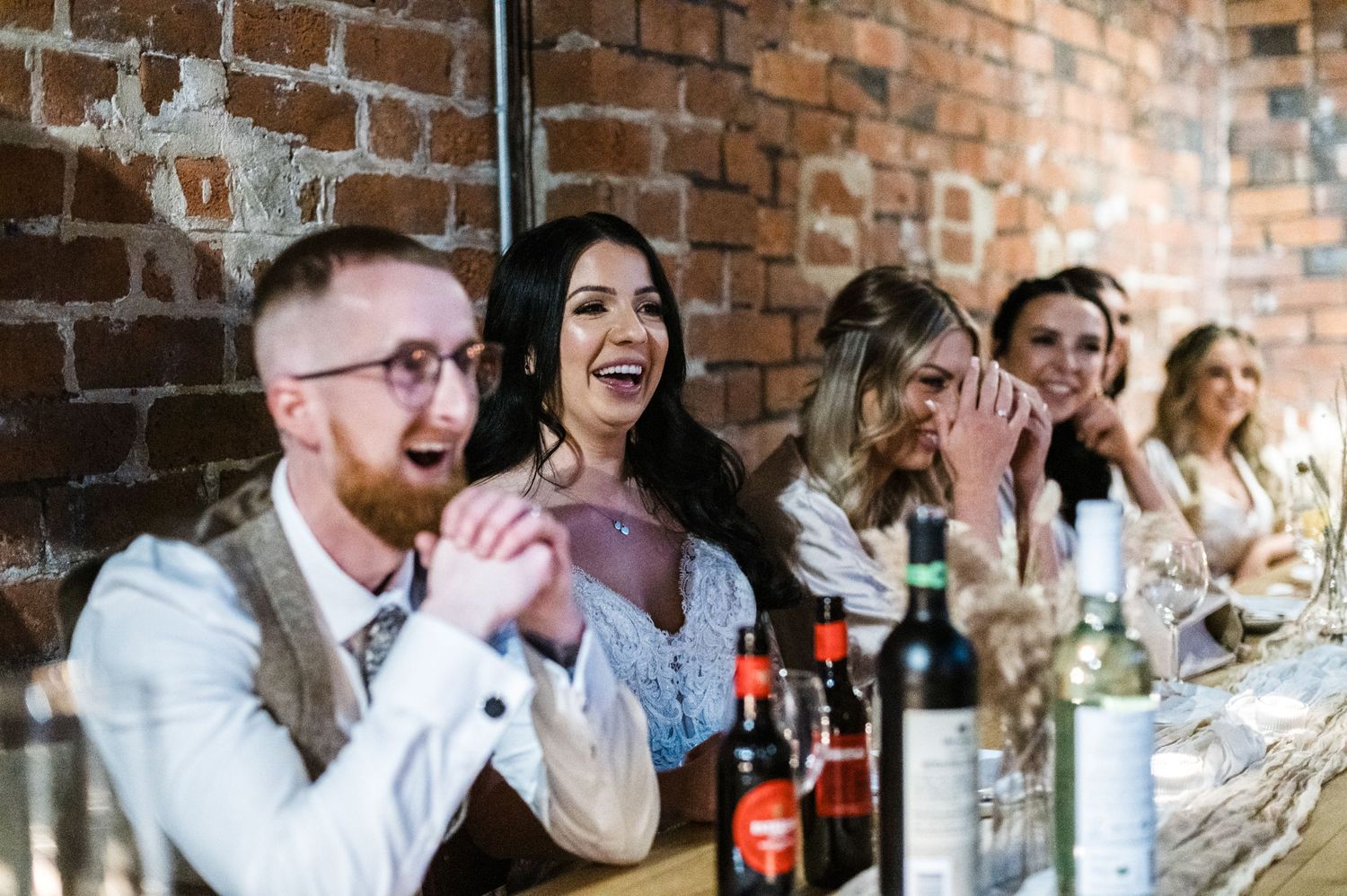 Joyful guests reacting with excitement during wedding reception festivities.