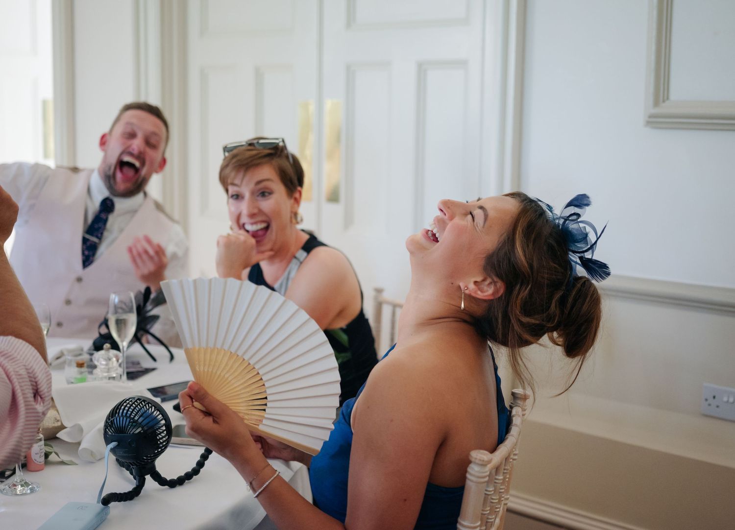 Candid moments of wedding celebration in an elegant white room.