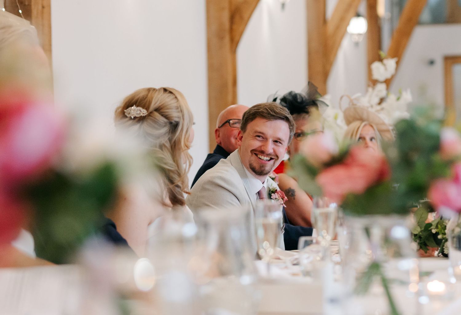 Close-up details of an elegant wedding reception with soft pink floral decorations.
