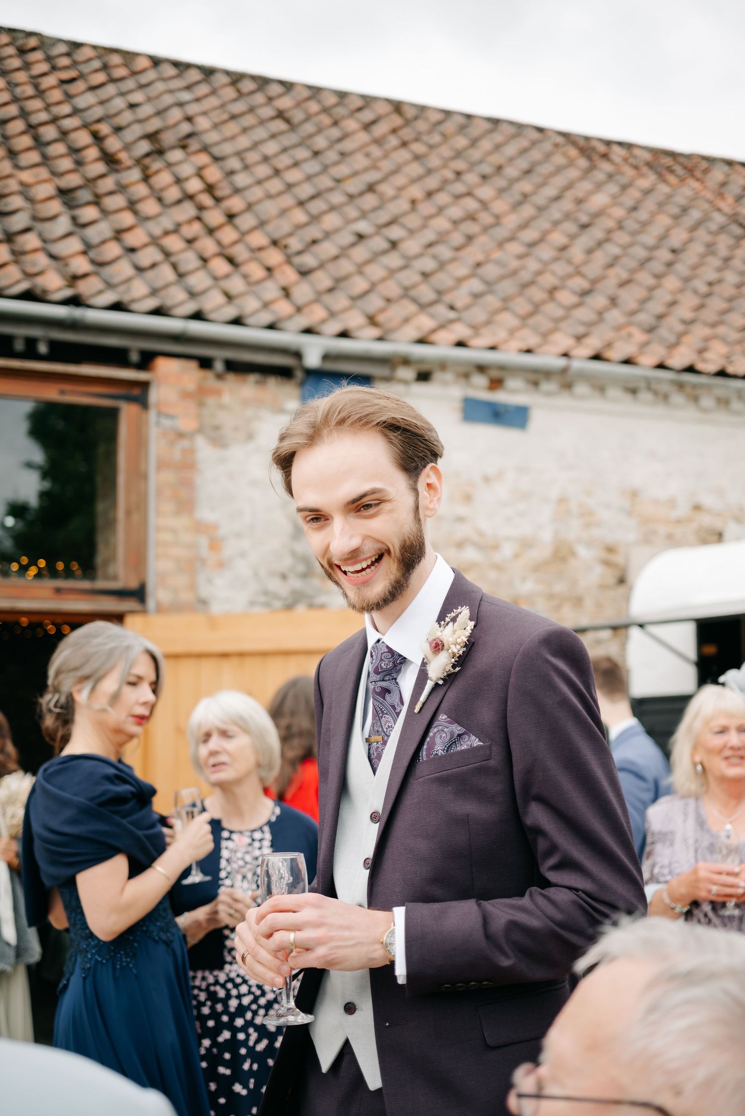 Wedding celebration at a charming venue with terracotta roof tiles and stone walls.