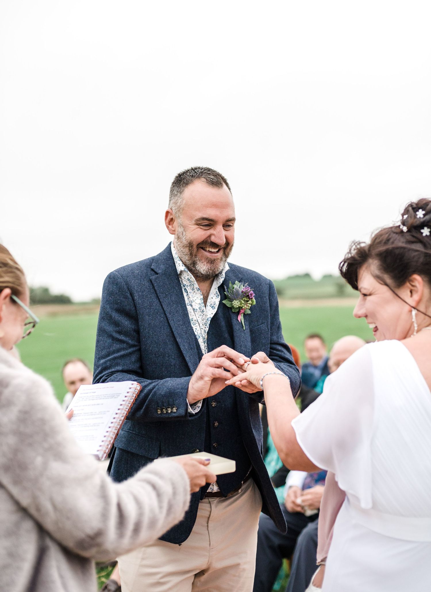 Outdoor wedding ceremony with exchange of rings.