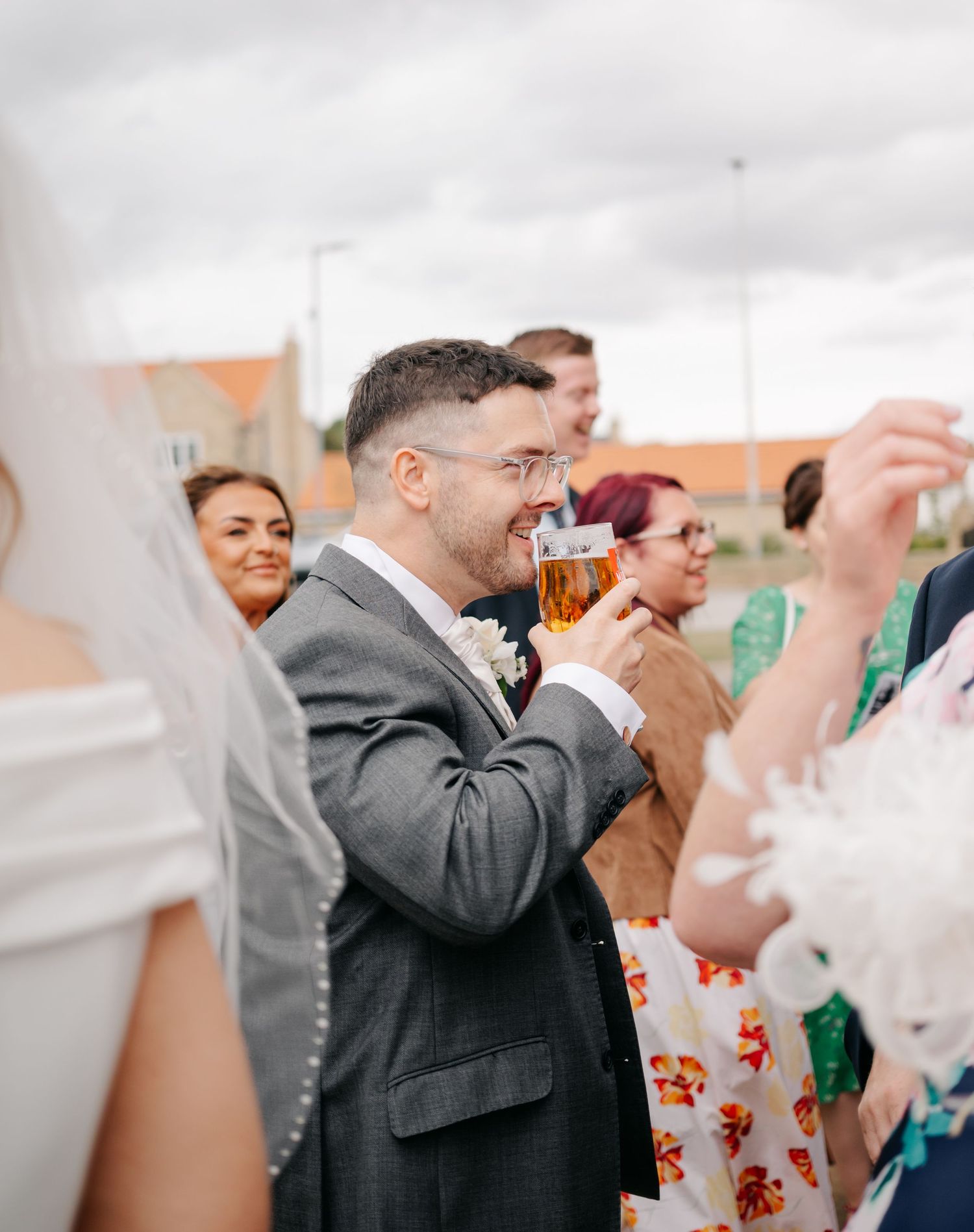 Guests raising glasses in celebration at a wedding reception.