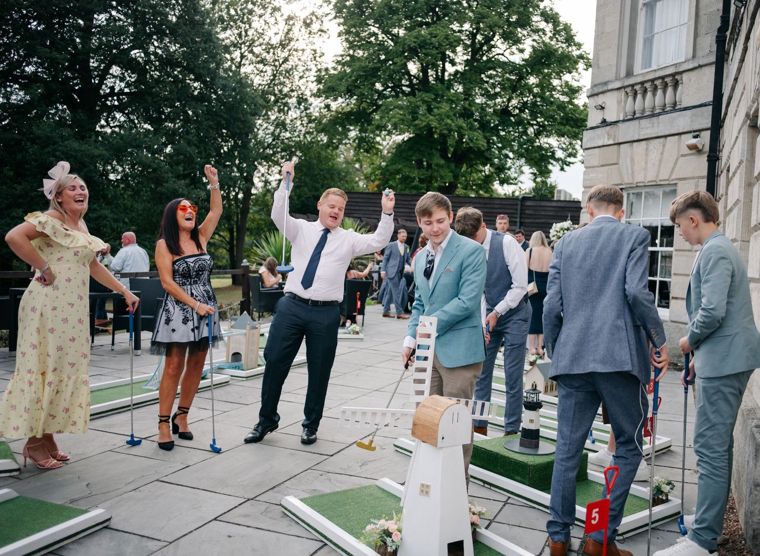 Wedding guests playing outdoor lawn games during the reception.