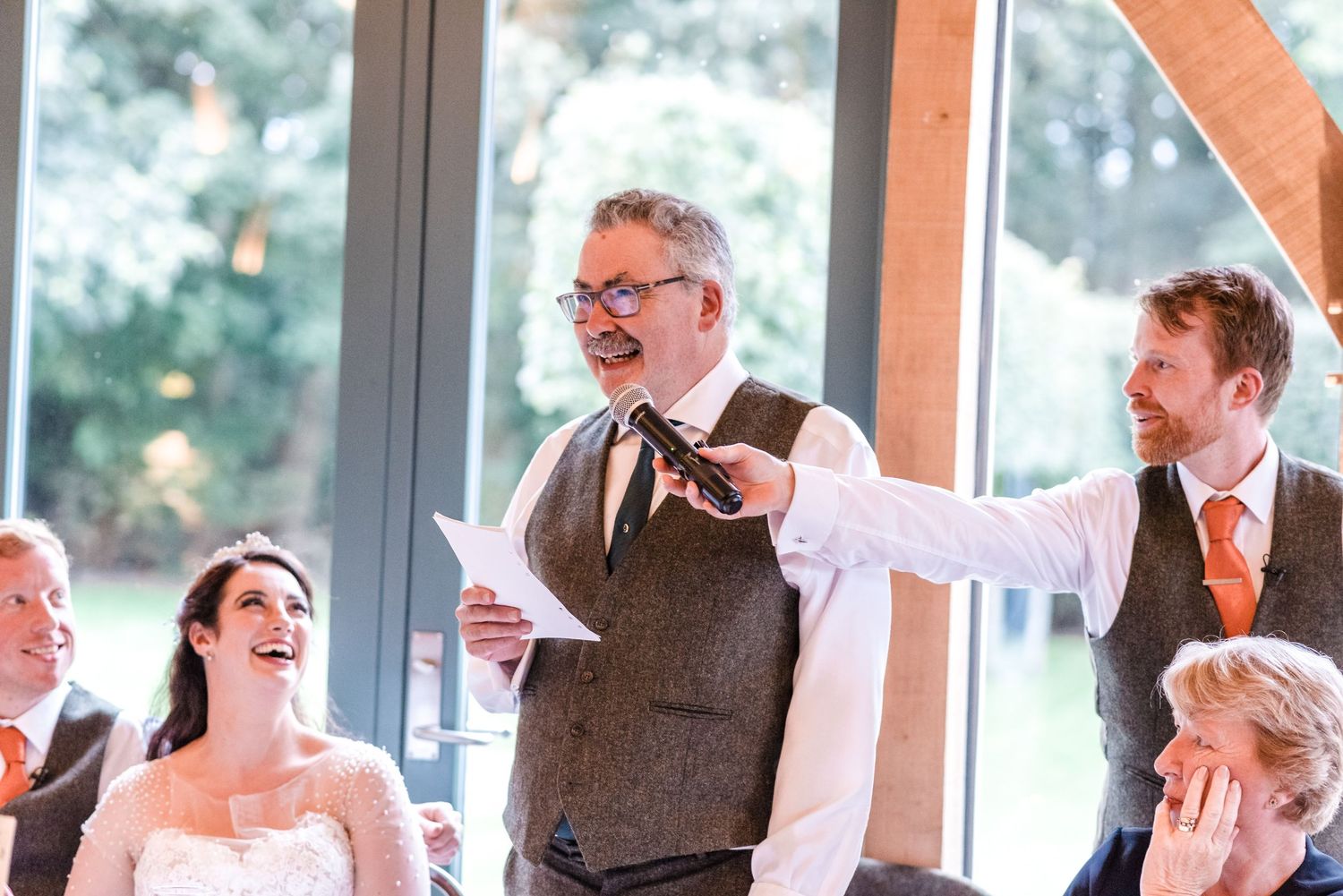 Wedding reception speech and reactions during indoor celebration.