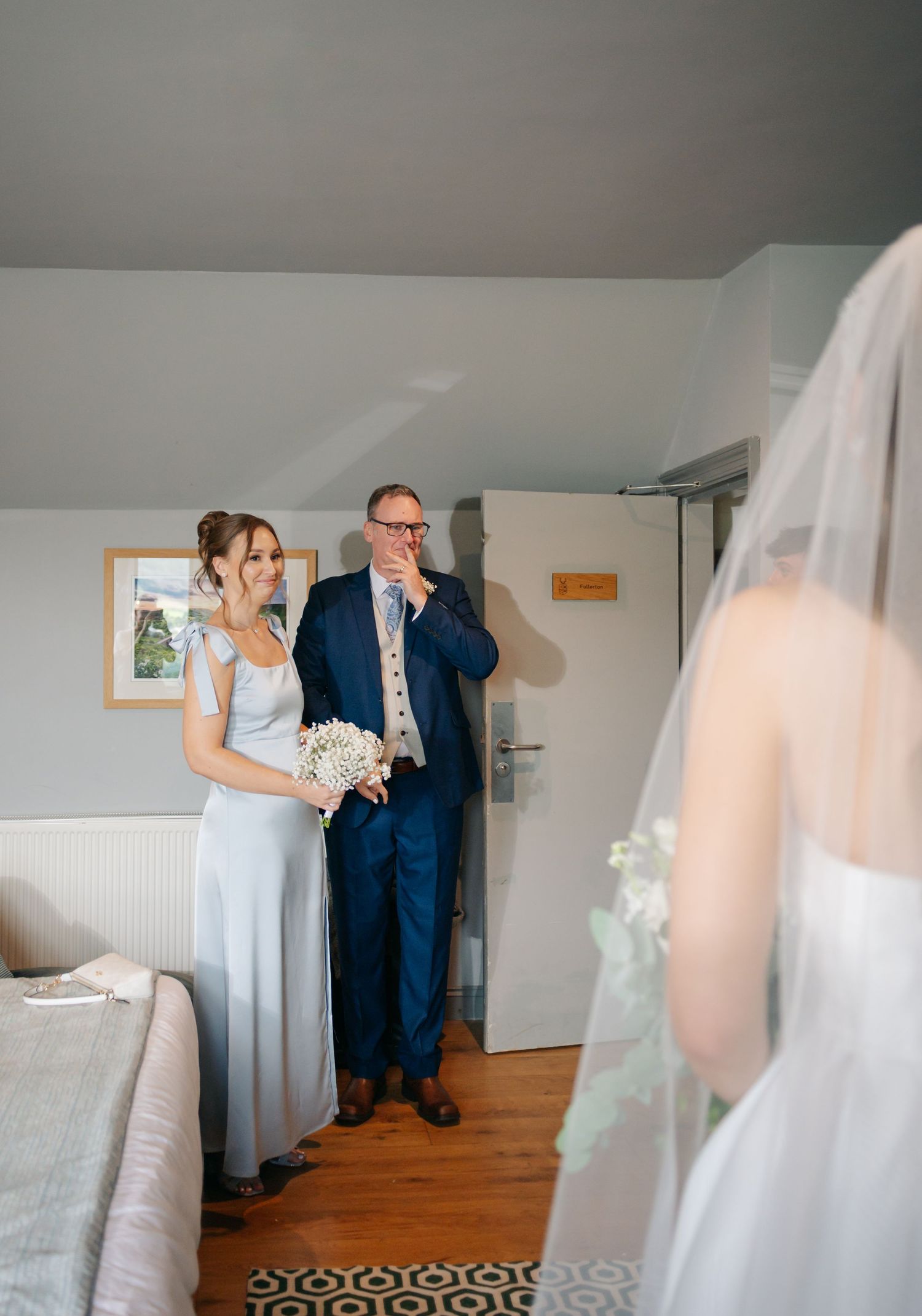 A series of emotional first look photos showing a touching moment between family members before a wedding ceremony.
