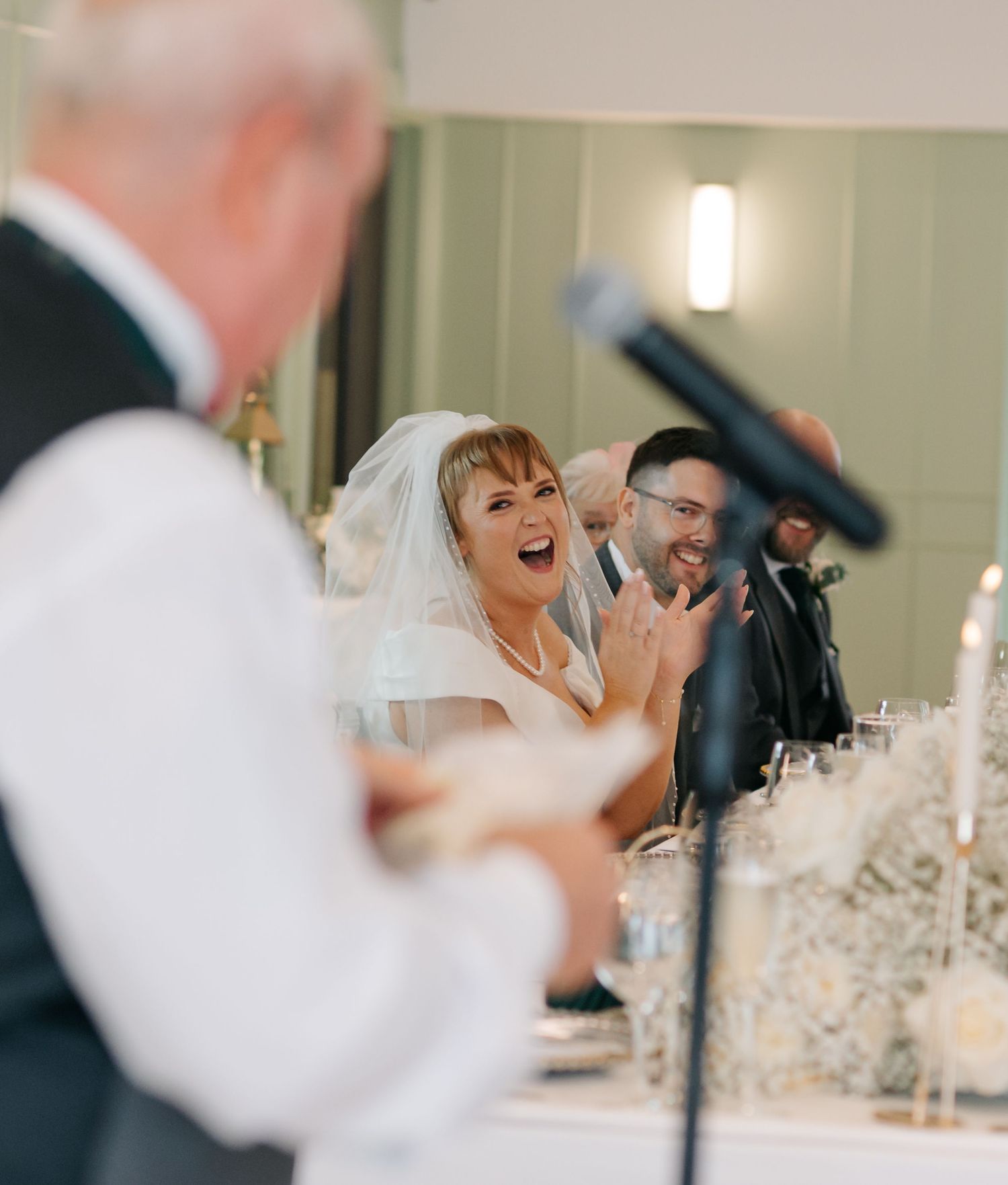 Candid reception moments captured in soft focus during wedding celebration indoors.