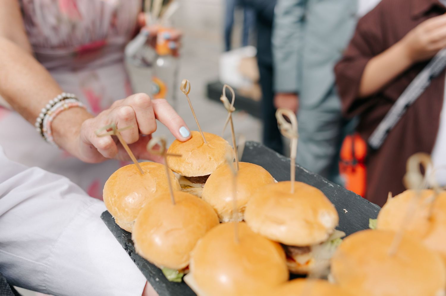 Close-up view of golden hamburger buns arranged in rows on a surface.