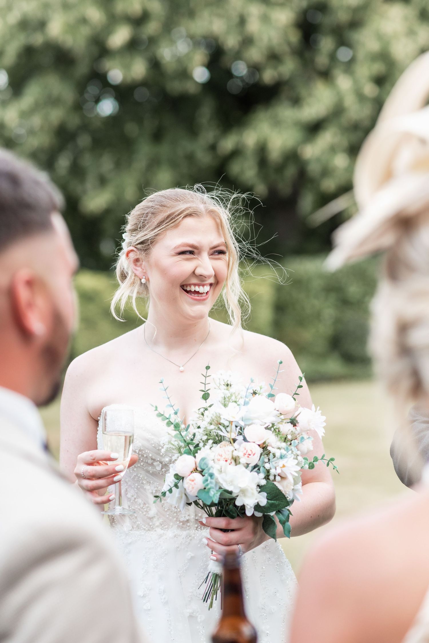 Beautiful wedding portrait moment outdoors with soft natural lighting and delicate floral bouquet.