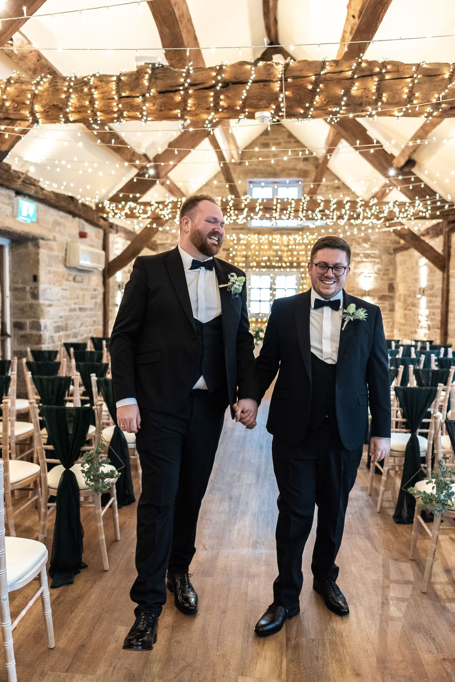 Rustic wedding venue with exposed wooden beams and twinkling string lights creating a warm ambiance.