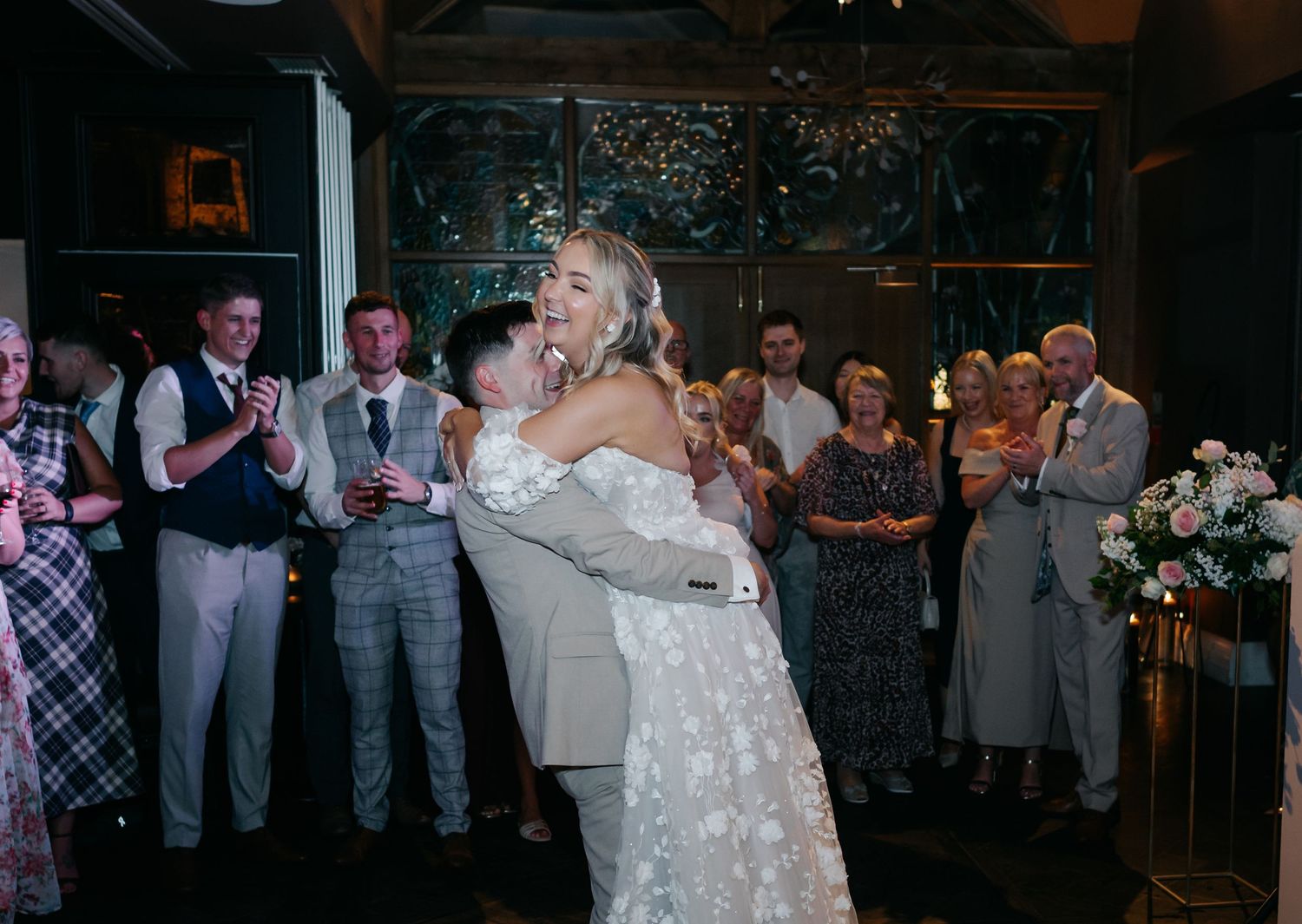 Wedding reception party scene with guests dancing under dim lighting at The Coach House venue.