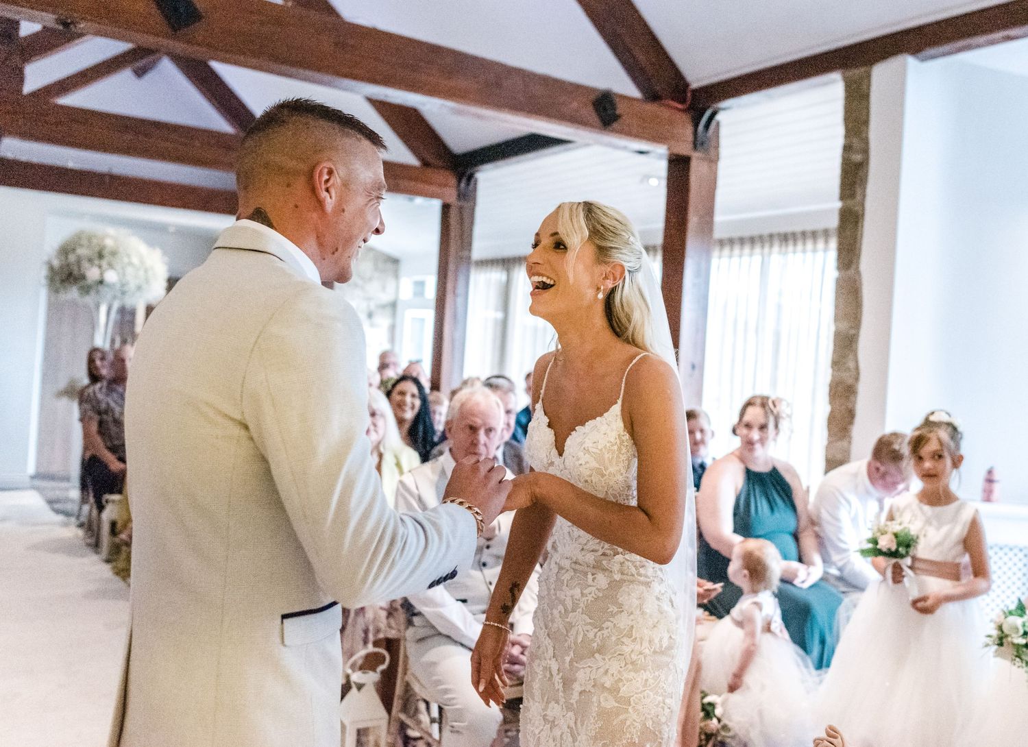 Bride and groom share a tender moment during their indoor wedding ceremony.
