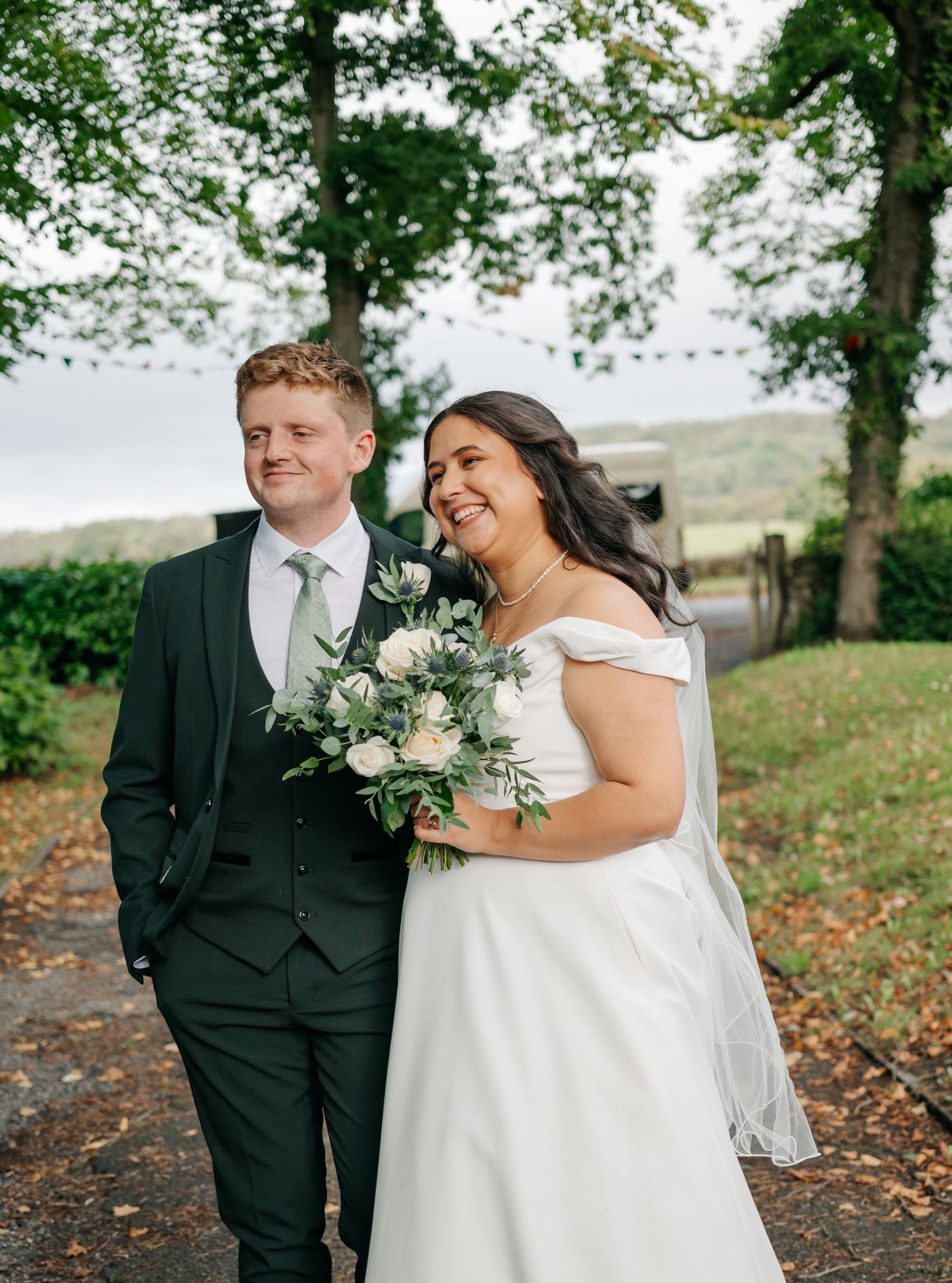 Couple sharing a joyful moment outdoors during their wedding photoshoot.