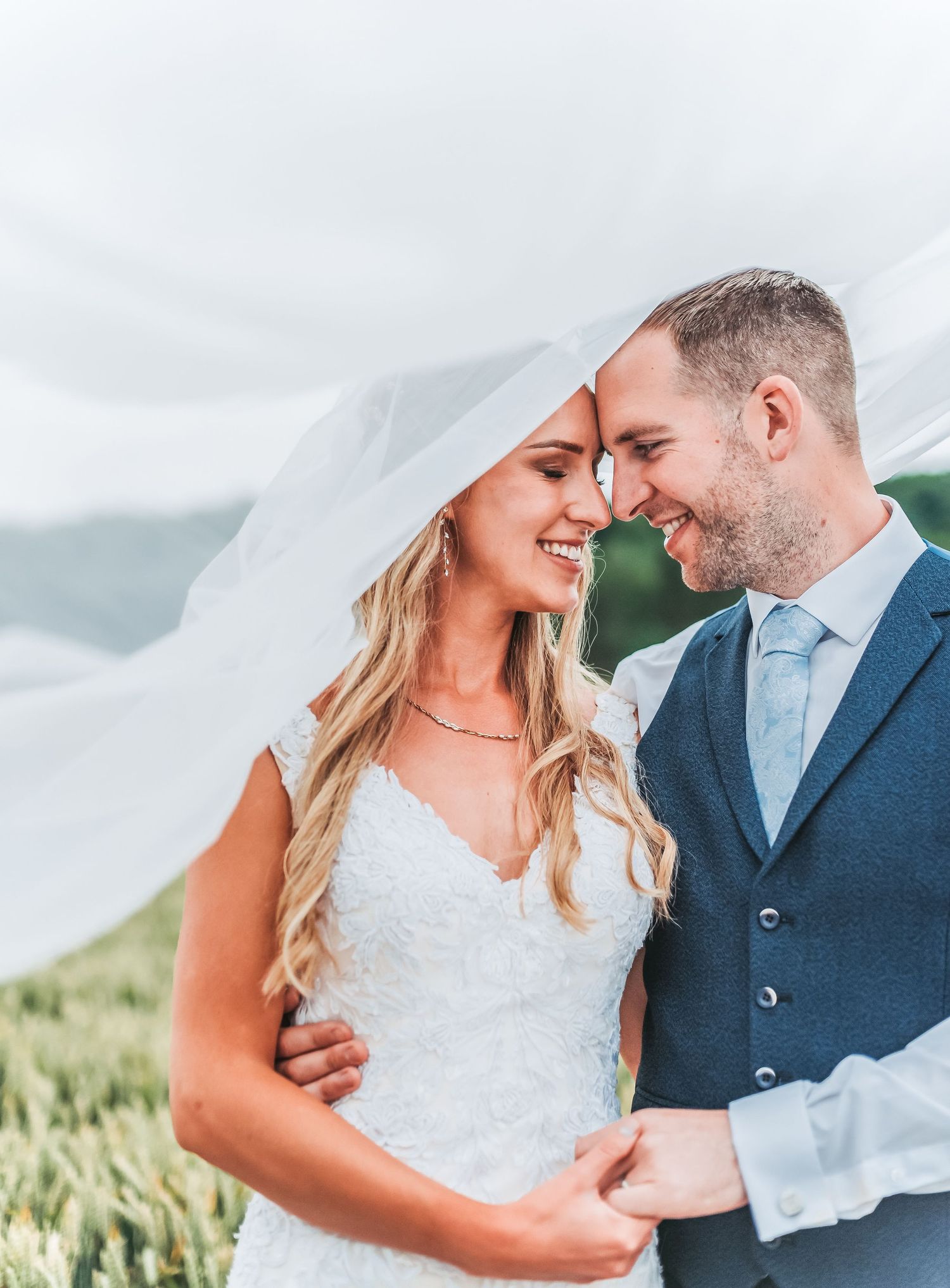 Romantic moment between newlyweds in a countryside setting.