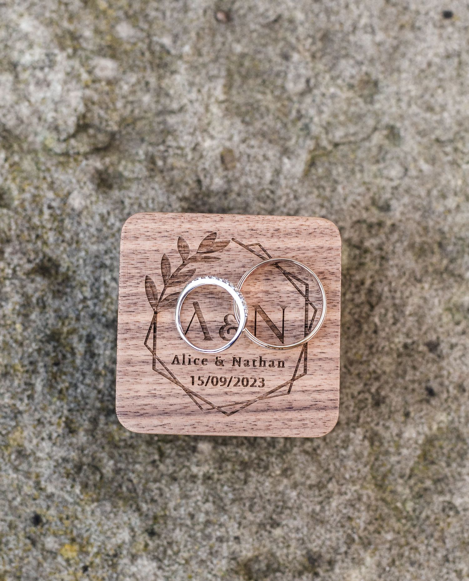 Wooden wedding coaster with laser engraved floral design and couple's names and date.