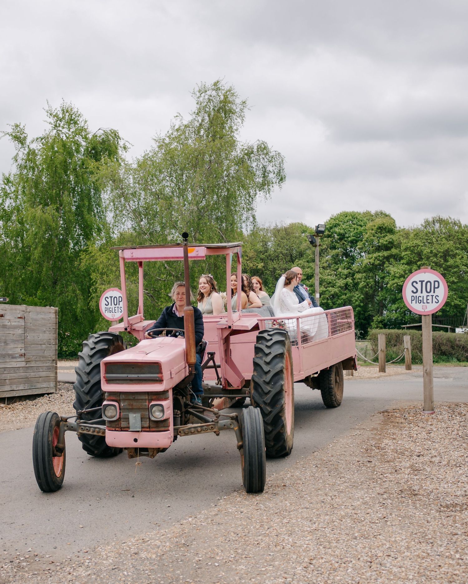 Vintage red tractors lined up at a rustic wedding venue.