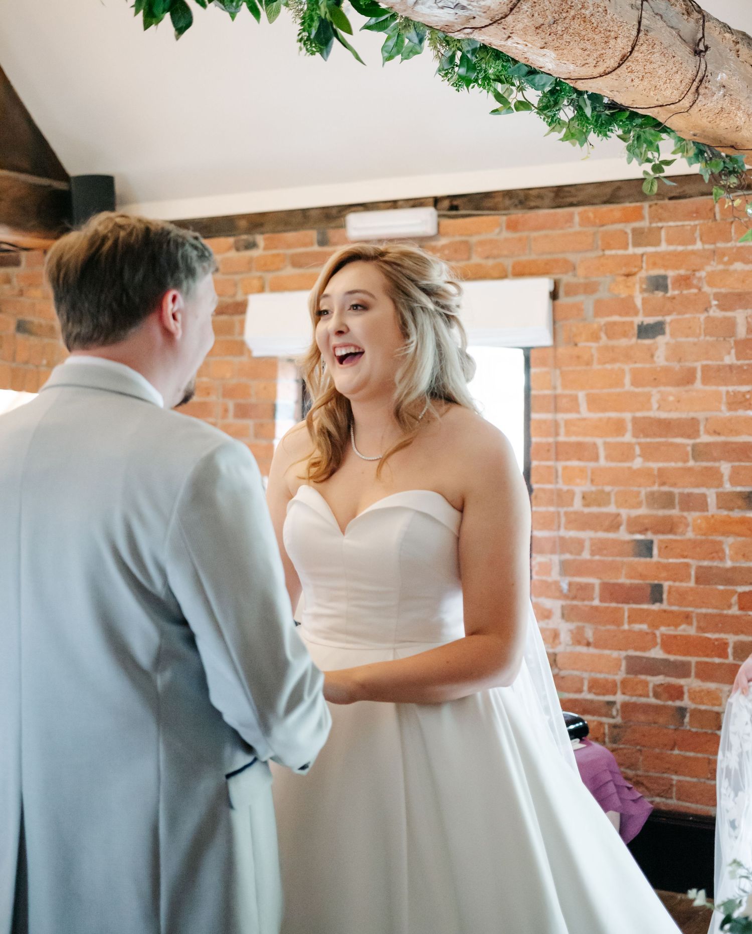 A series of intimate moments showing couple in wedding attire against brick wall backdrop.