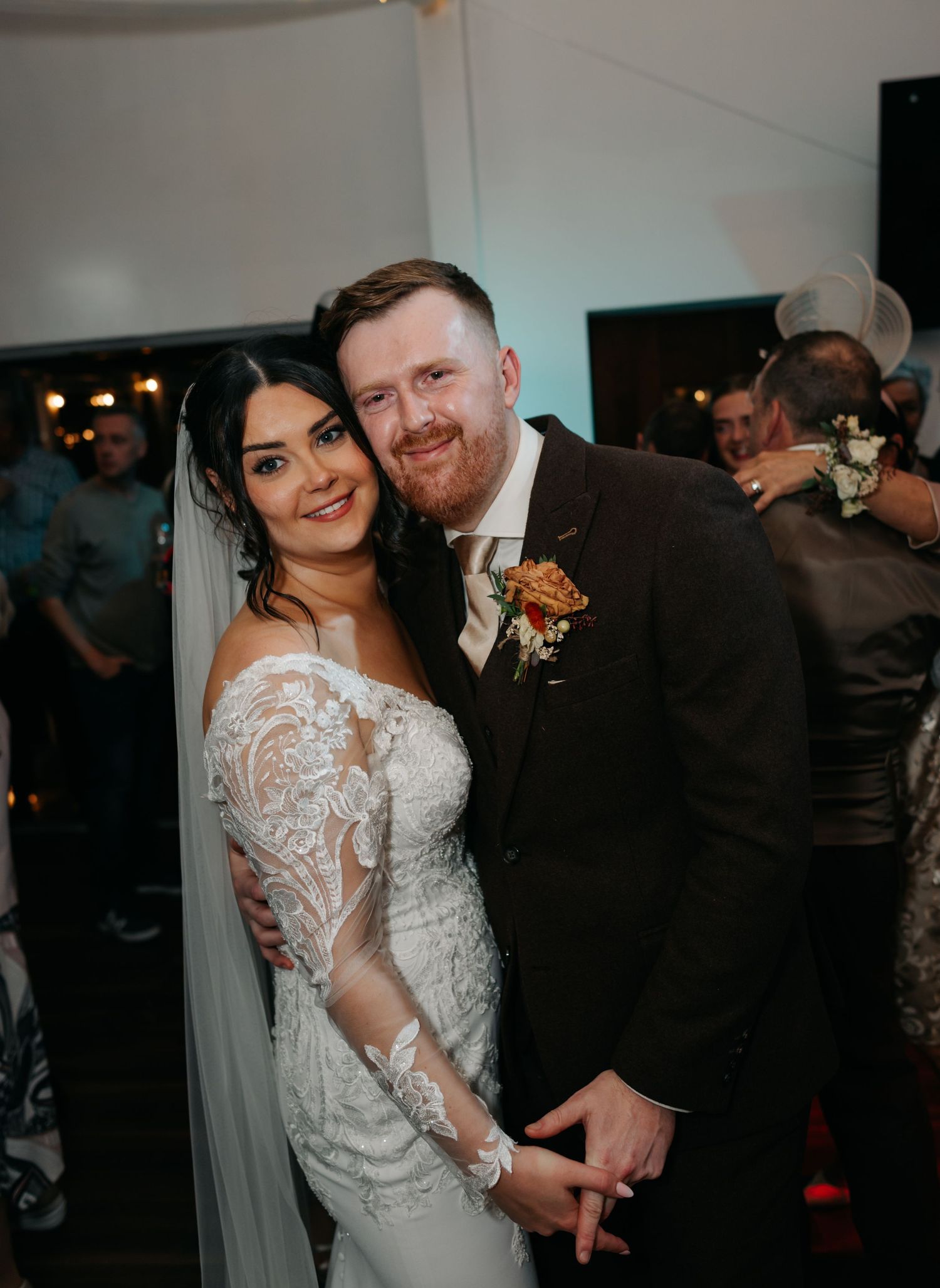Romantic reception dance moment captured in low light with elegant decor.