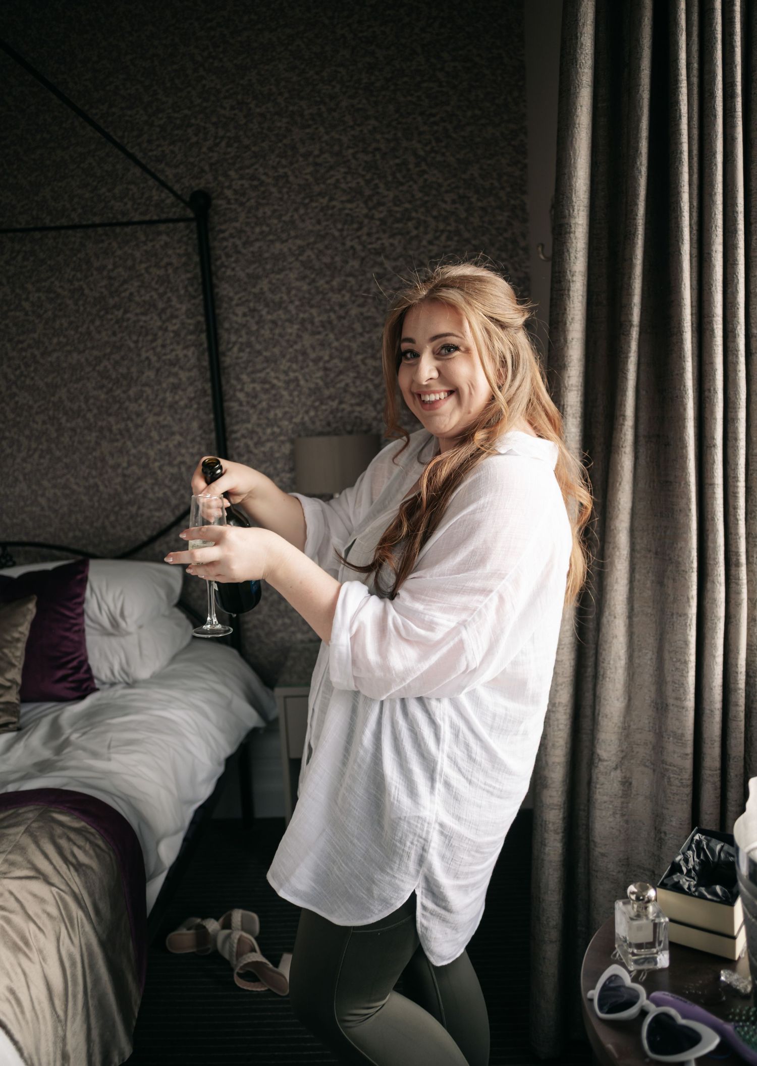 Series of candid moments showing someone in white getting ready in a dimly lit hotel room.