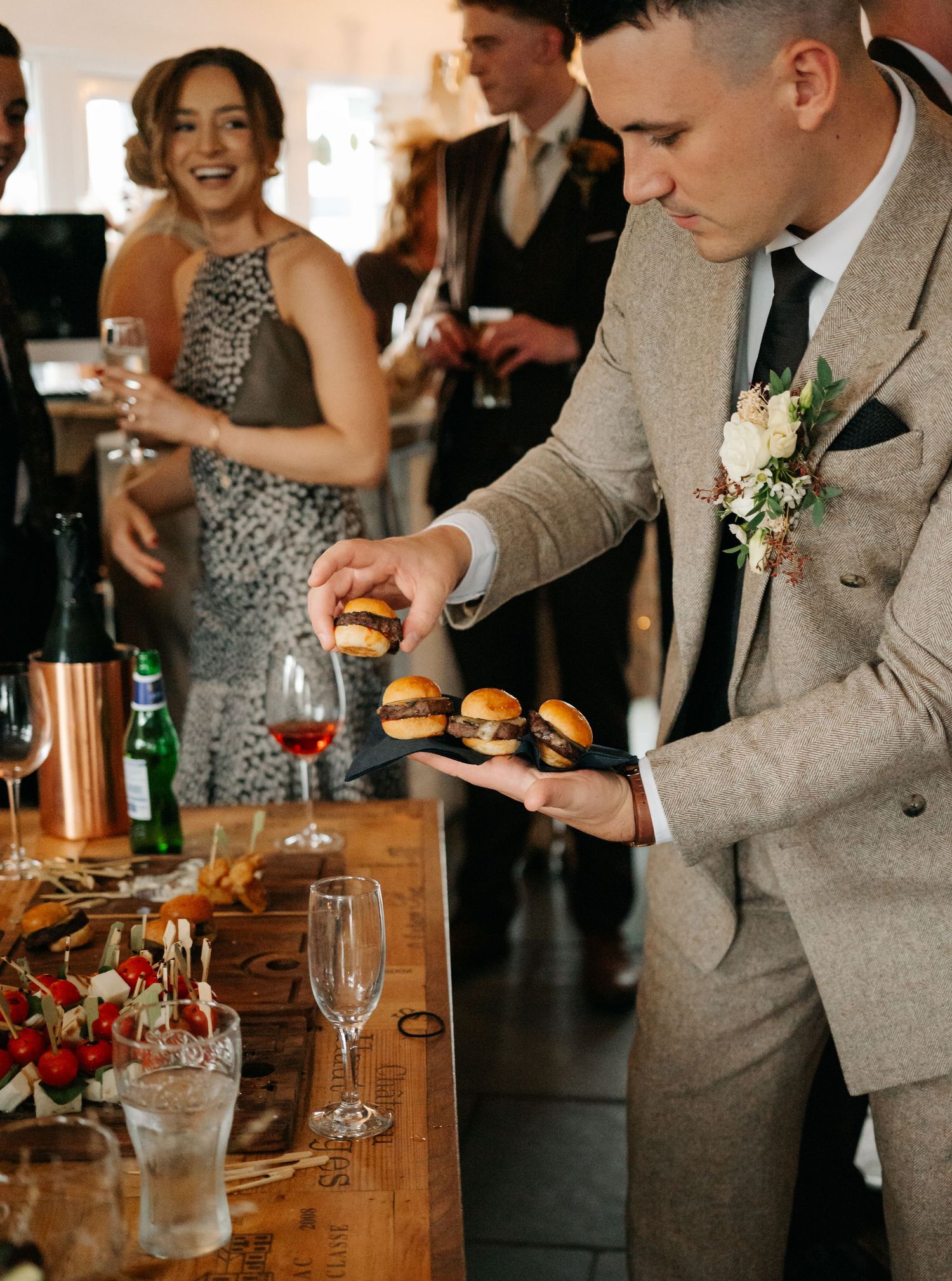 Wedding guests enjoying drinks and appetizers at an elegant cocktail reception.