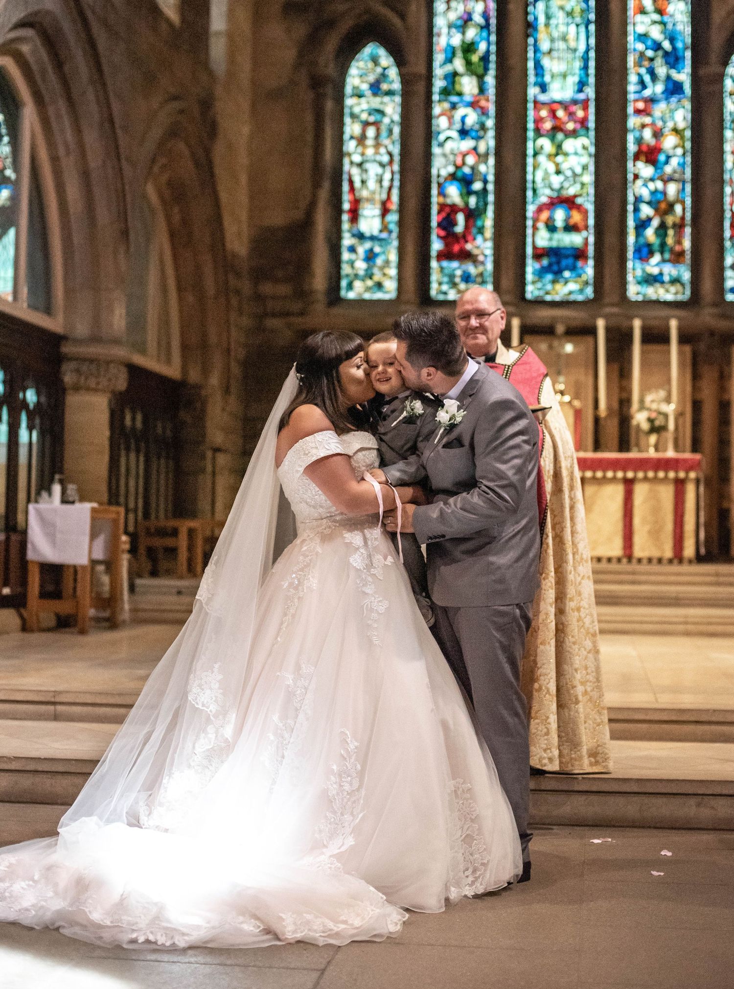 A beautiful wedding ceremony in a historic church with stained glass windows.
