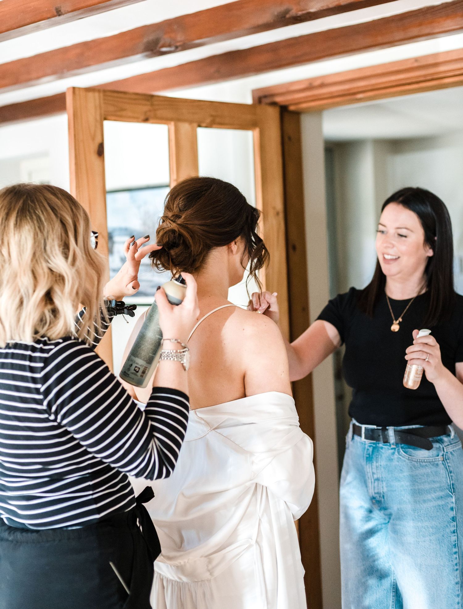 Wedding morning preparation scene with people in white robes getting ready.