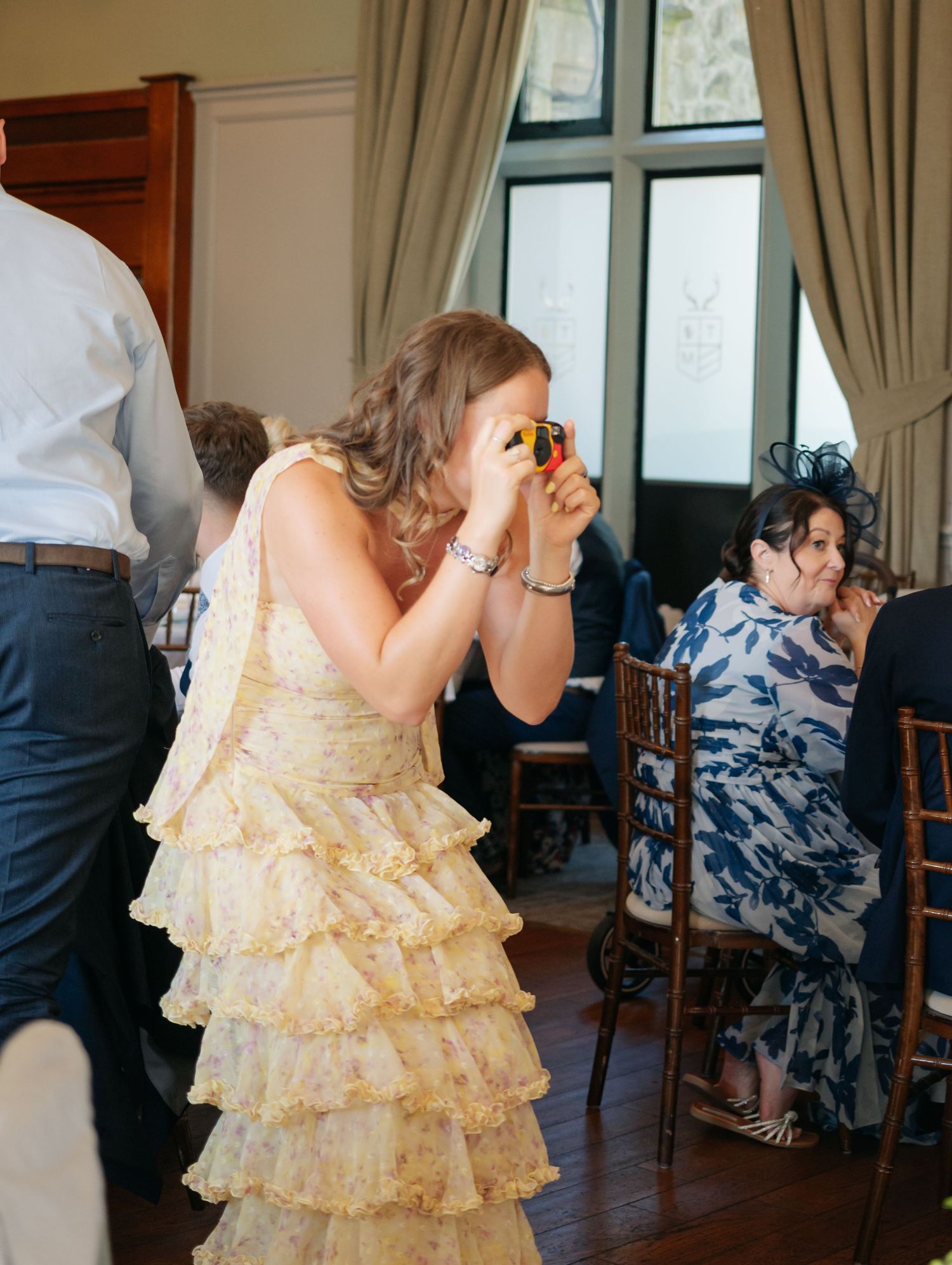 Wedding guests dancing in formal wear with ruffled dresses.