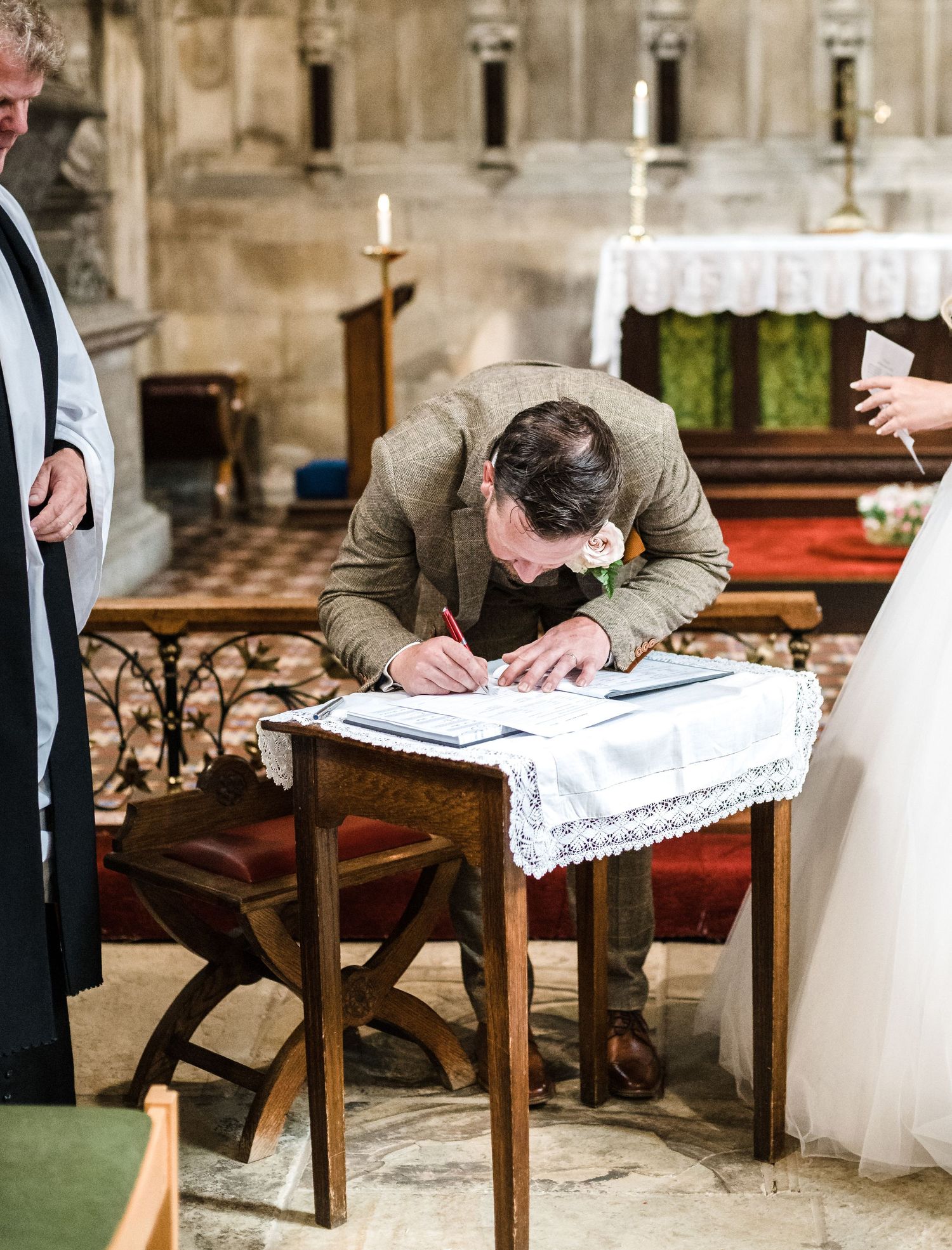 Wedding register being signed during church ceremony.