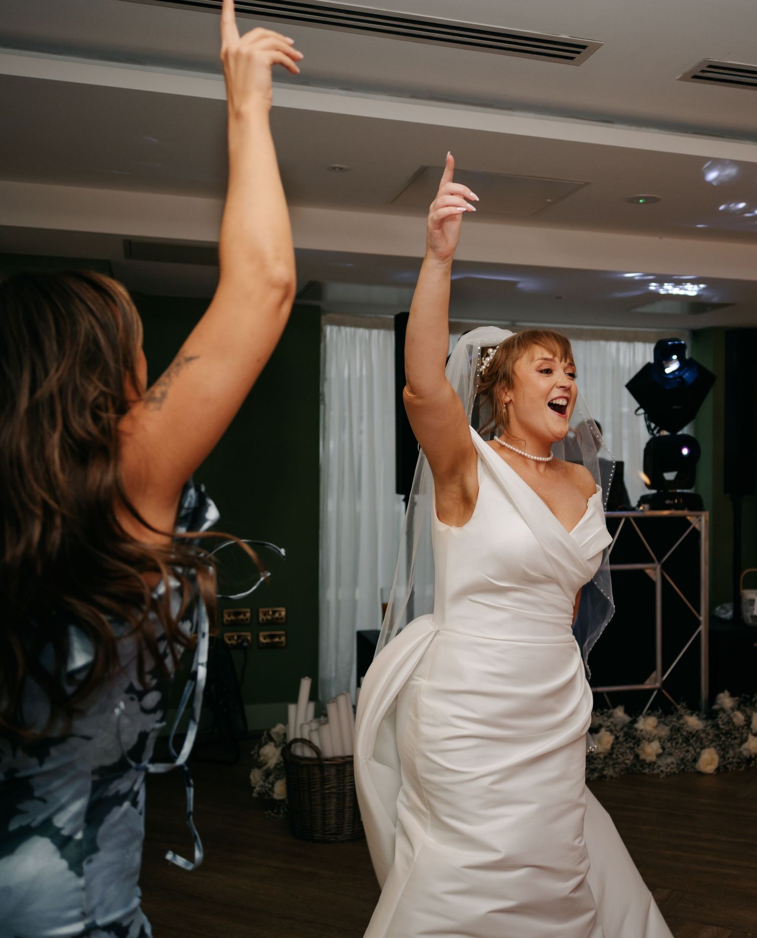 Sequence of photos showing a bride dancing energetically in a white dress at a wedding reception.